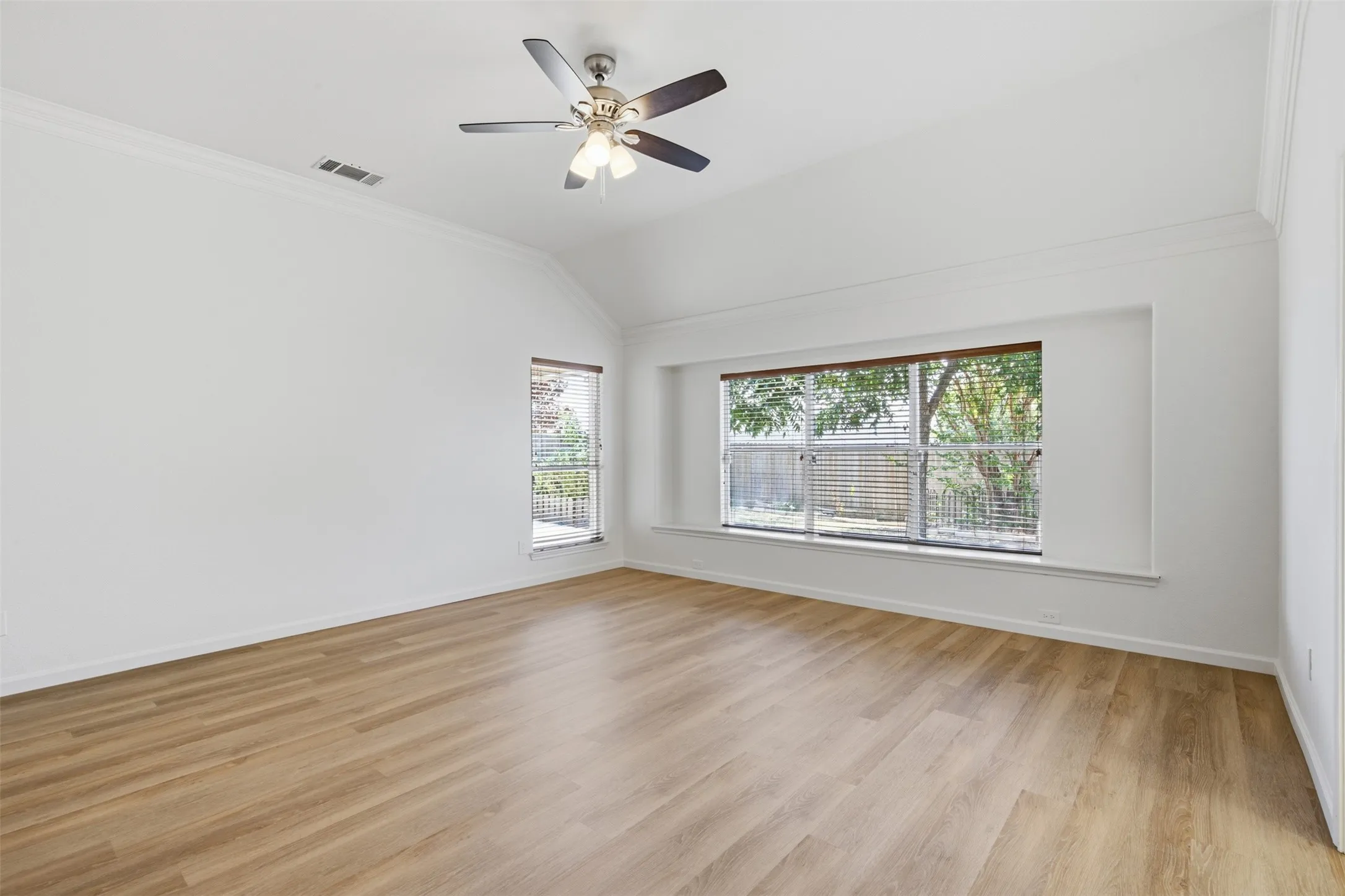 Lots of natural light along with freshly painted walls and new luxury vinyl plank flooring in master bedroom of 10232 Ash Creek Lane listed by Seth Fowler of Williams Trew Real Estate