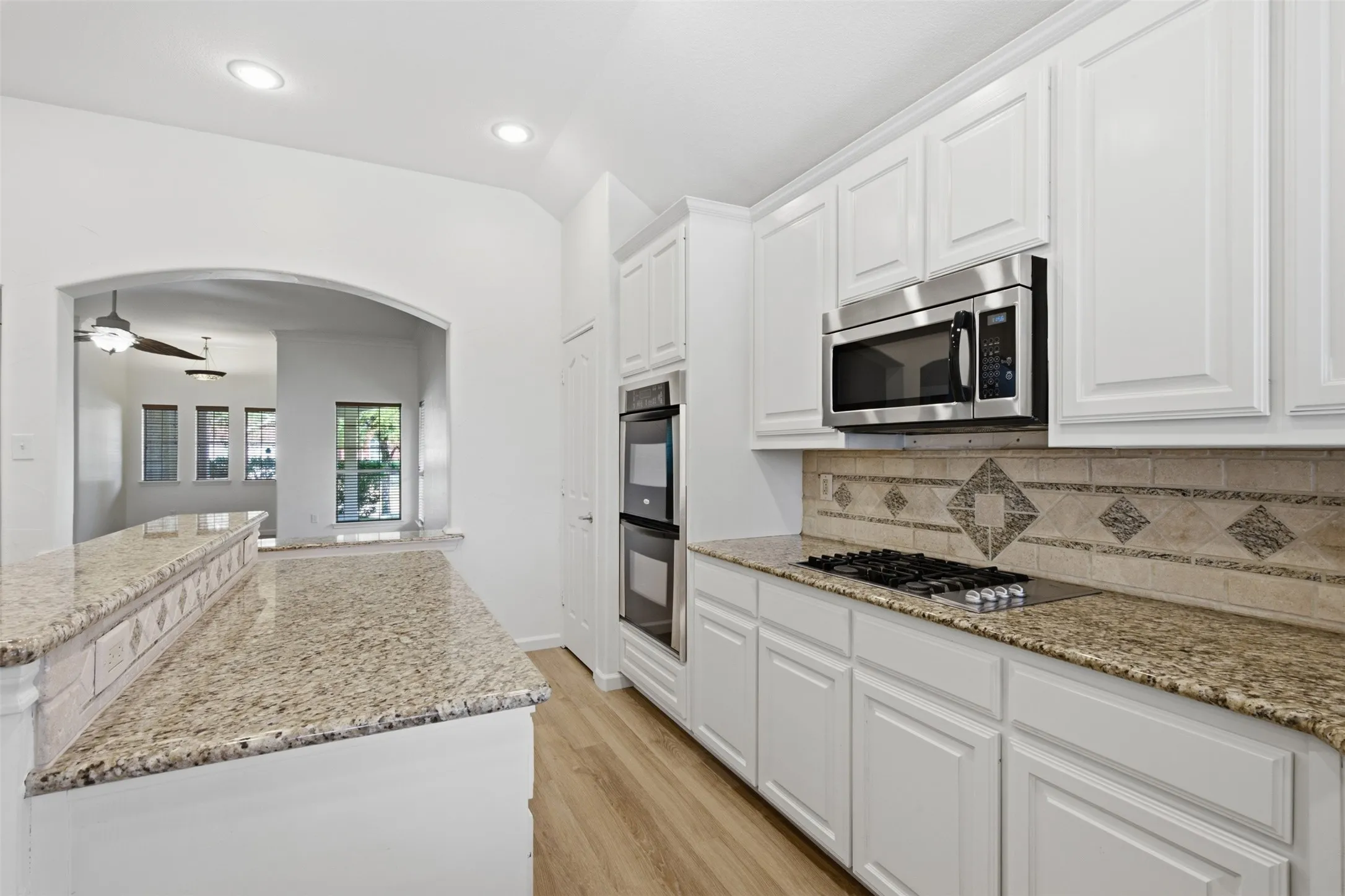 Granite counters, double ovens, gas cooktop at 10232 Ash Creek Lane by Seth Fowler of Williams Trew Real Estate