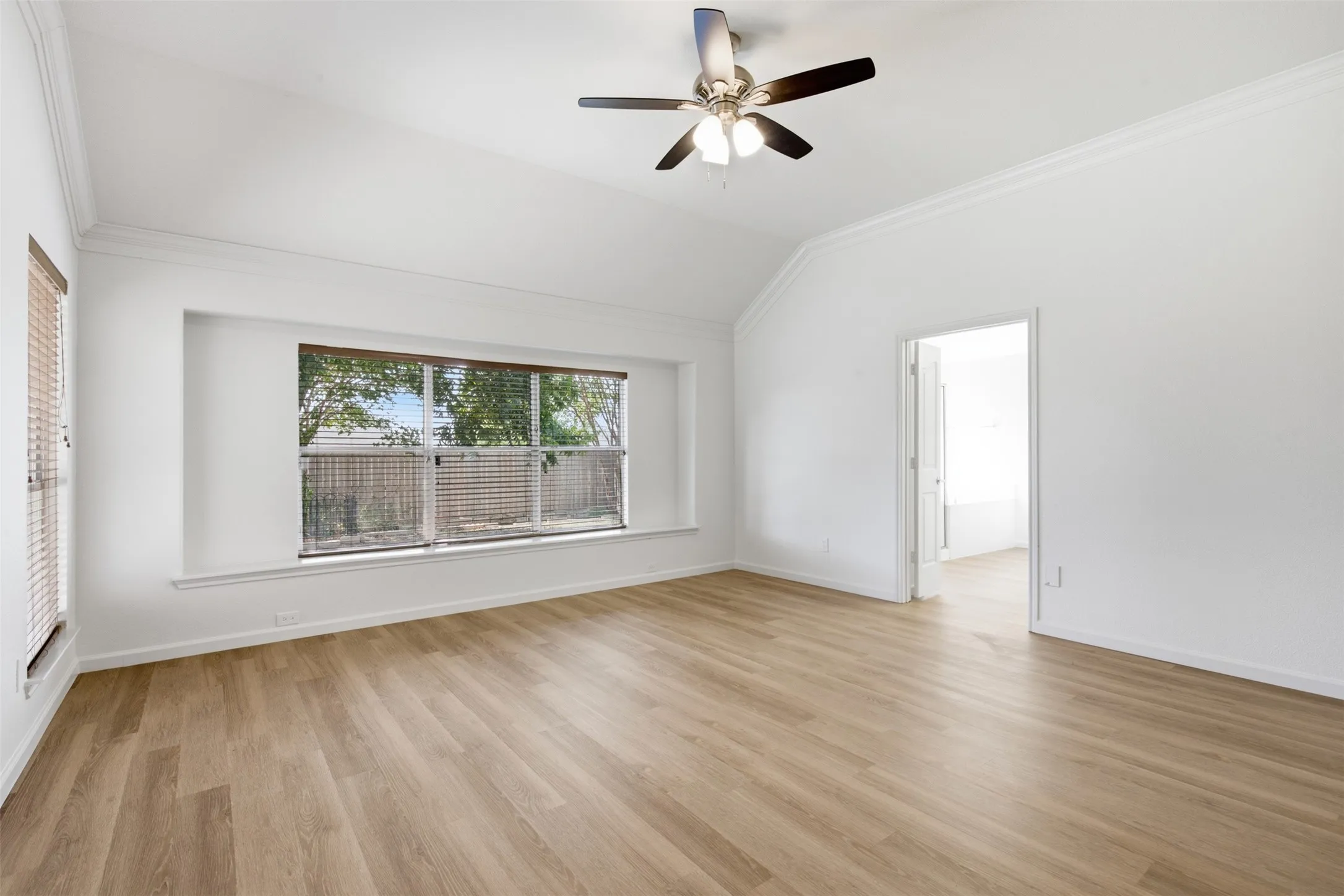 Lots of natural light along with freshly painted walls and new luxury vinyl plank flooring in master bedroom of 10232 Ash Creek Lane listed by Seth Fowler of Williams Trew Real Estate