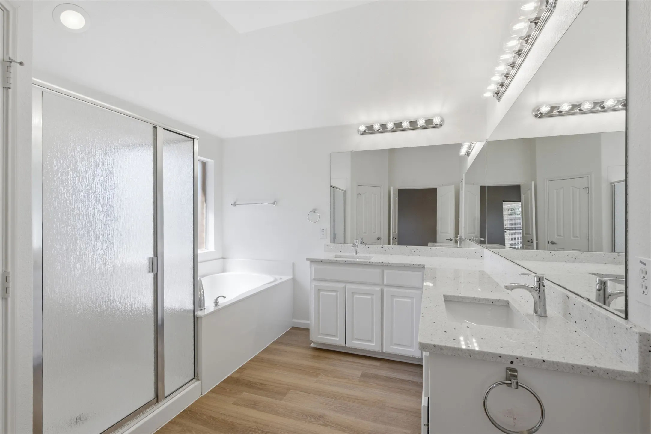 Ensuite primary bathroom with large walk-in closet, brand new counters and plumbing fixtures, separate shower and deep tub at 10232 Ash Creek Lane by Seth Fowler of Williams Trew Real Estate