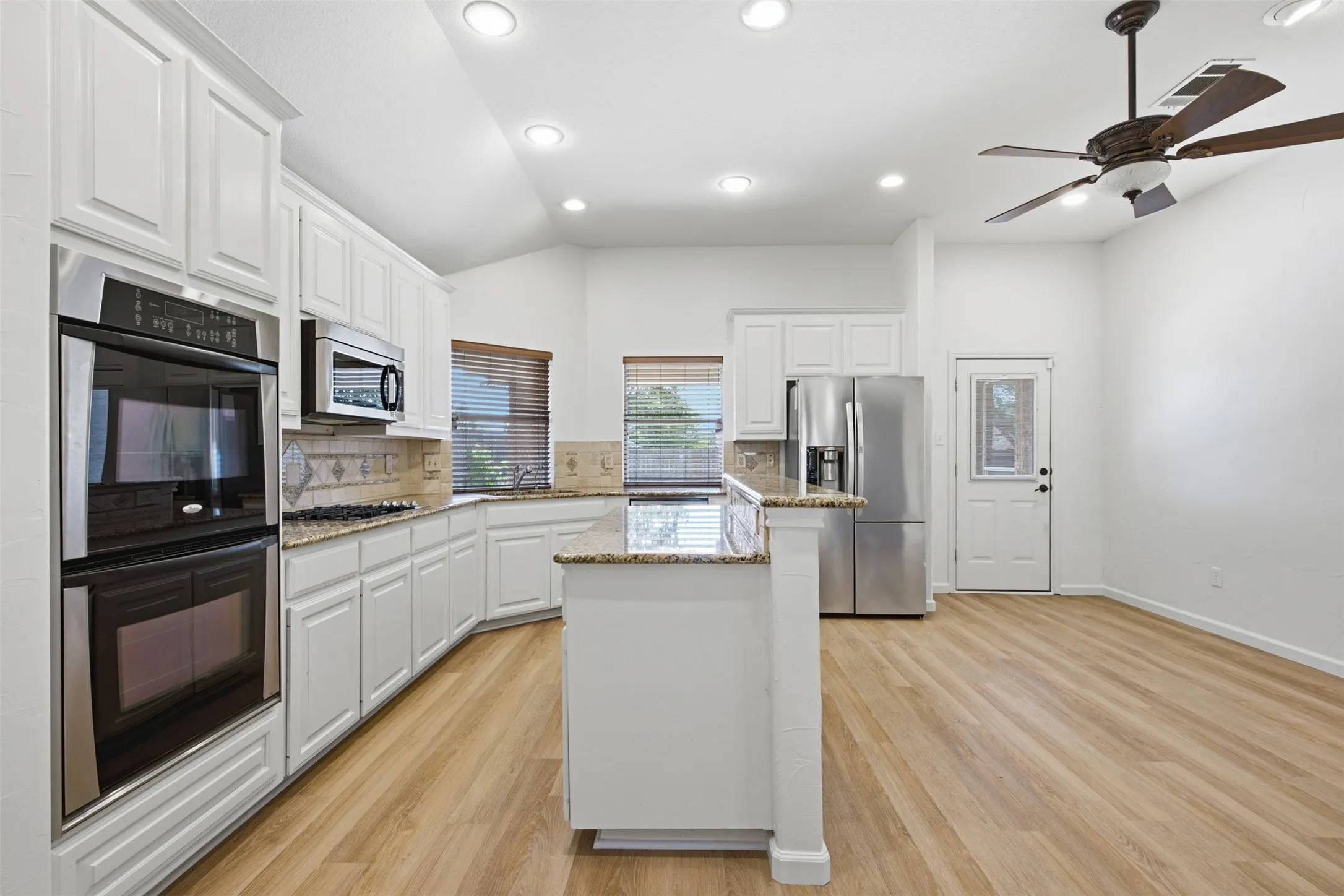 Granite counters, double ovens, gas cooktop at 10232 Ash Creek Lane by Seth Fowler of Williams Trew Real Estate