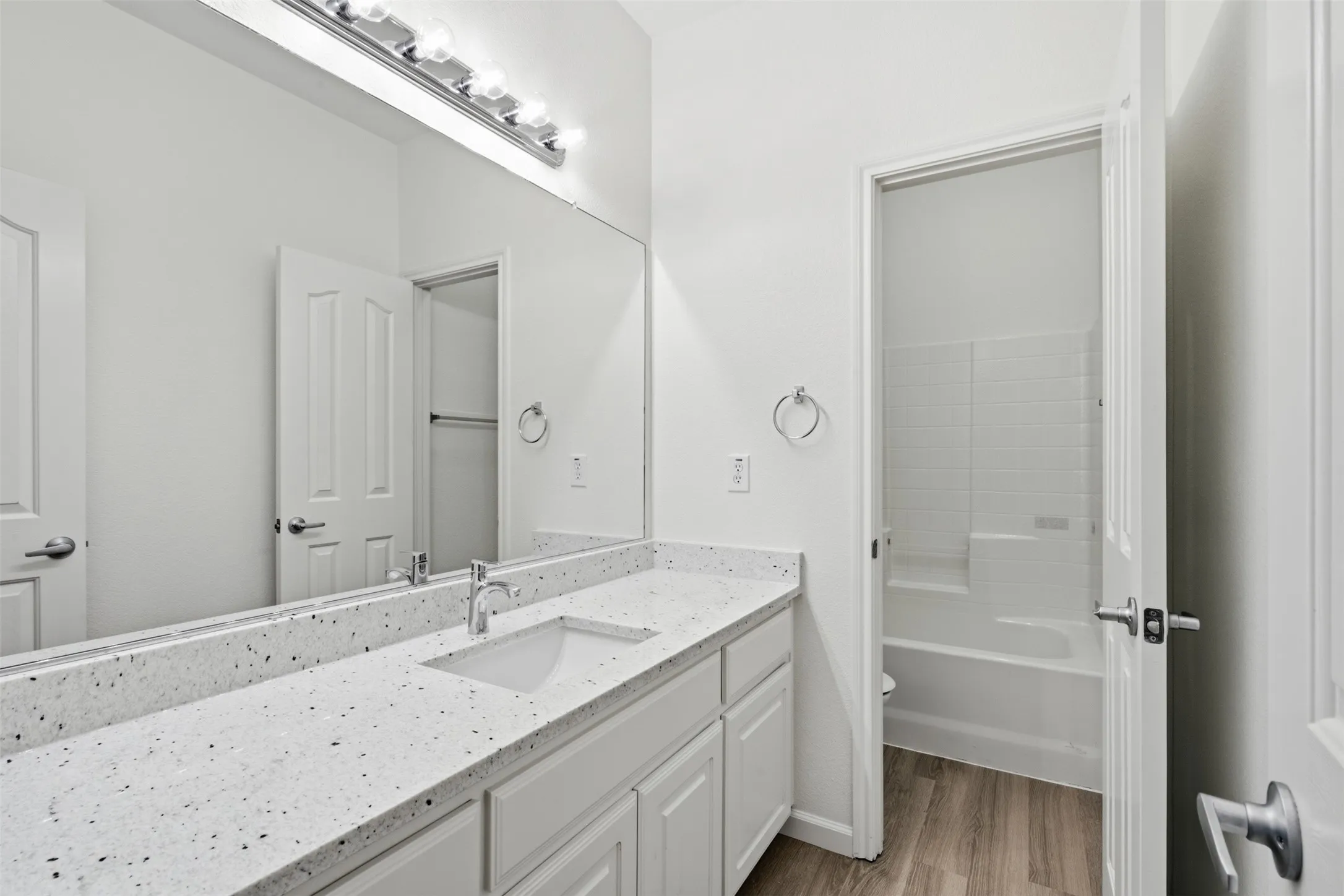 Secondary bathroom is freshly painted, new luxury vinyl plank floors and granite counters at 10232 Ash Creek Lane by Seth Fowler of Williams Trew Real Estate