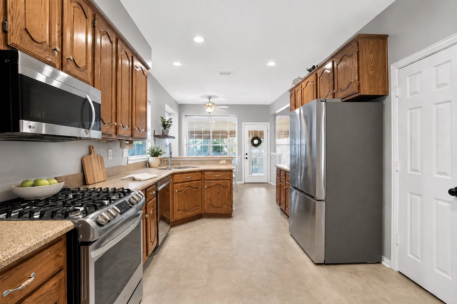 Lots of cabinet storage and a separate pantry area with a door.