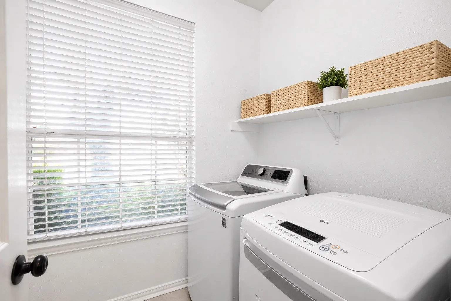 First floor laundry room featuring a window
