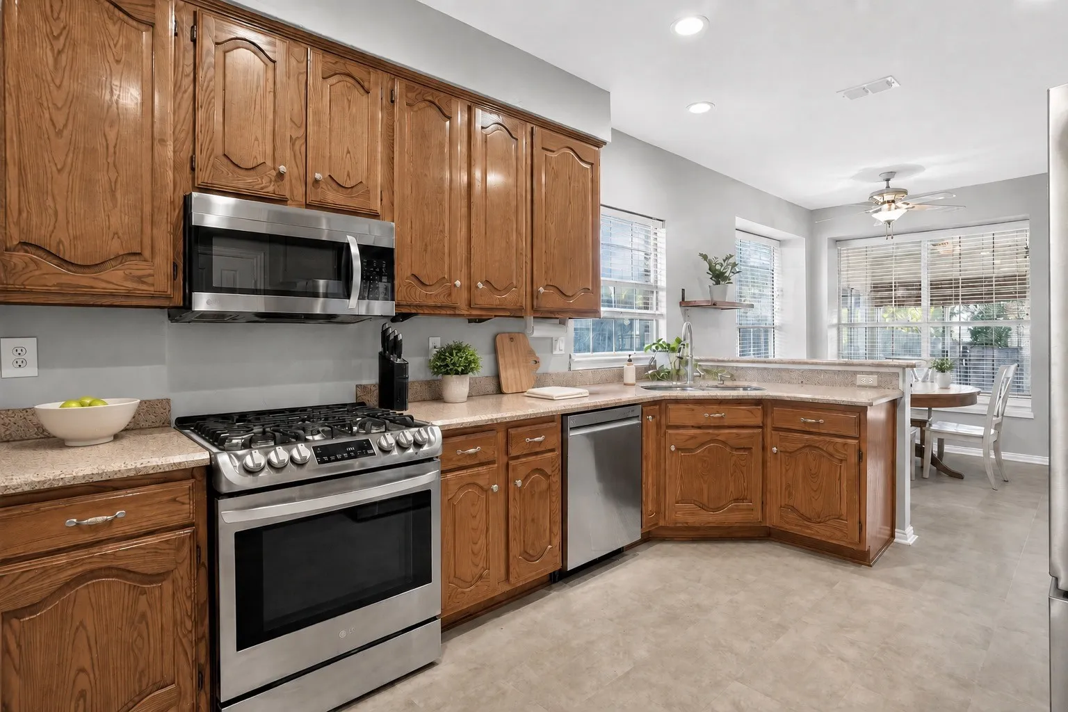 Spacious kitchen with wood cabinetry and stainless appliances