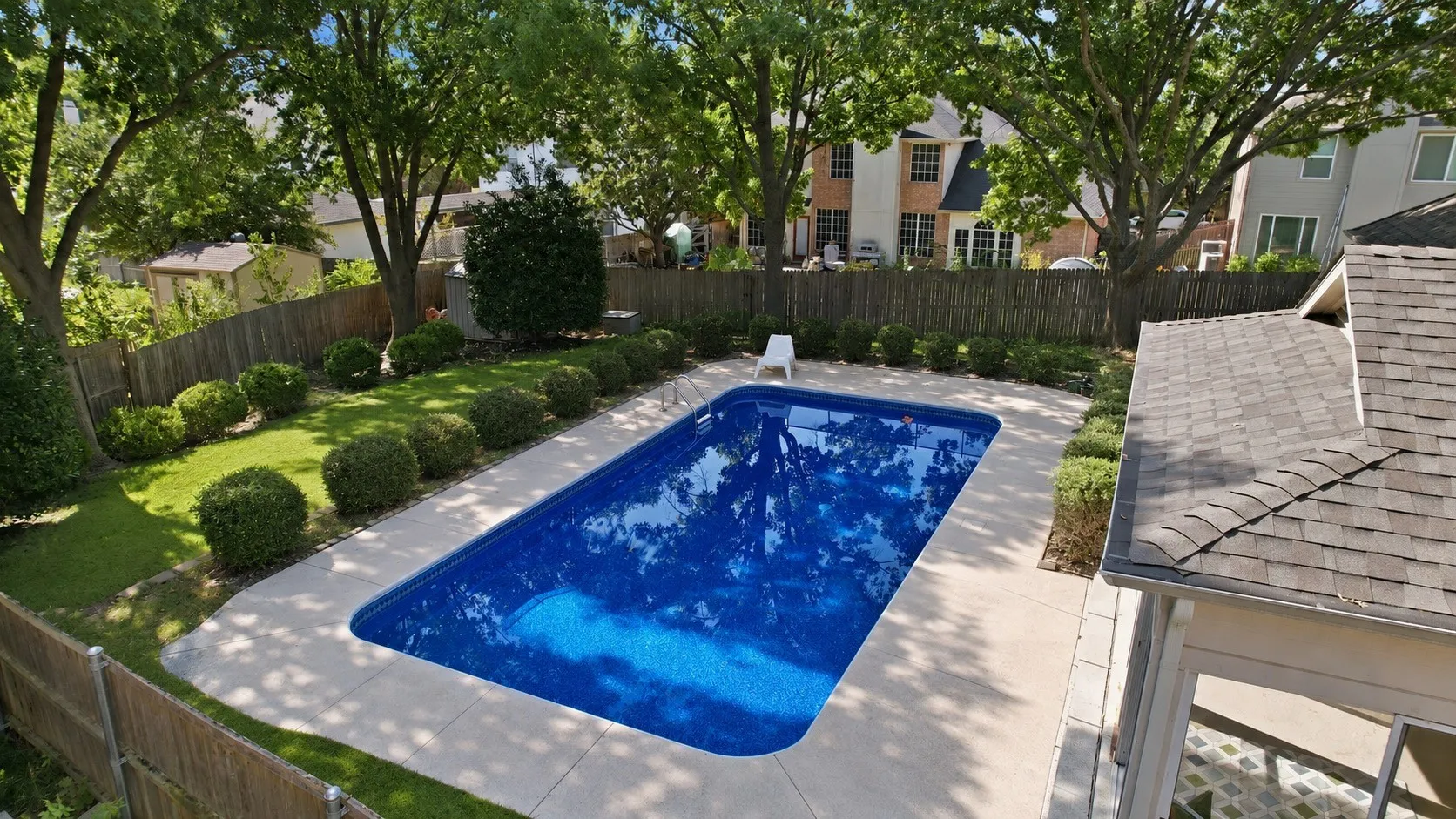Perfect backyard including a closed in patio, outdoor patio, a large pool, a shed and a grassy area.