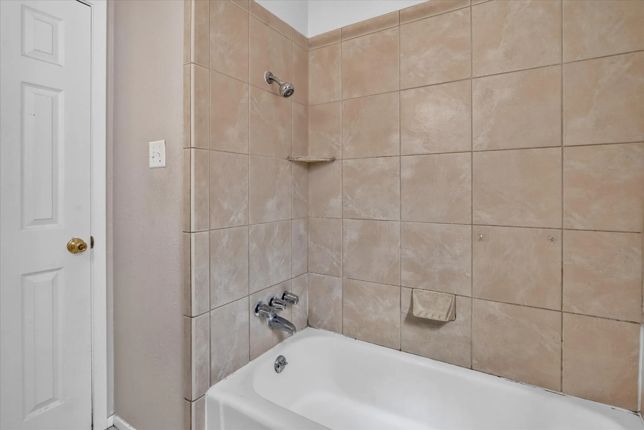 White vanity with integrated sink, chrome-finish faucet, and a large wall mirror