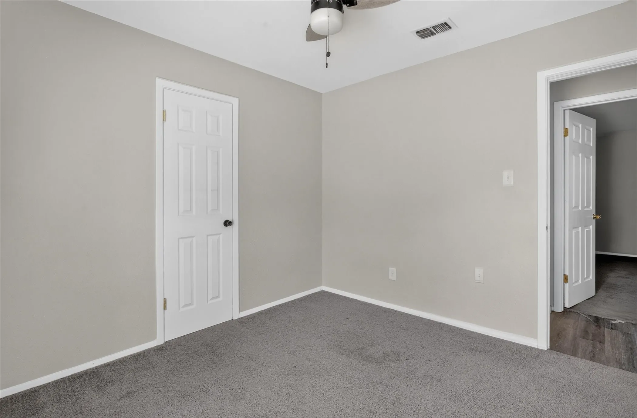 Wall-to-wall carpeting and neutral wall tones