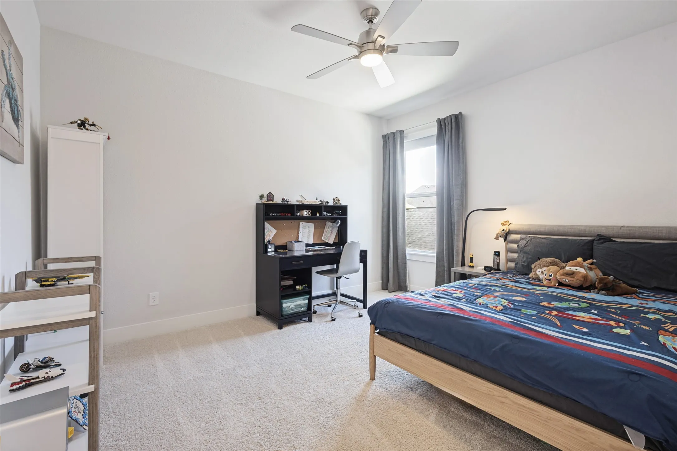 Plush carpet flooring, recessed window, ceiling fan with integrated lighting, and neutral wall tones