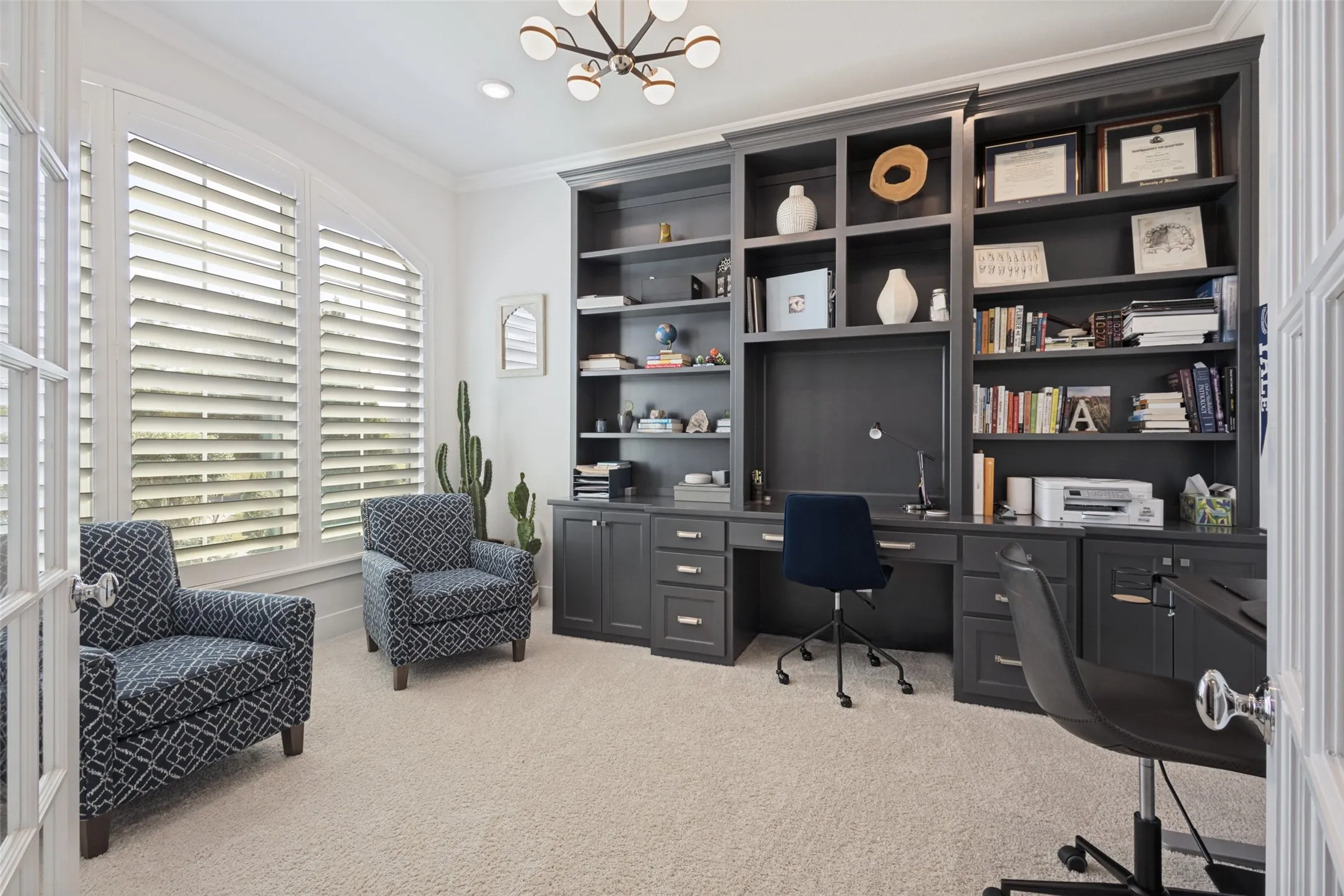 Built-in shelving and desk unit with dark cabinetry