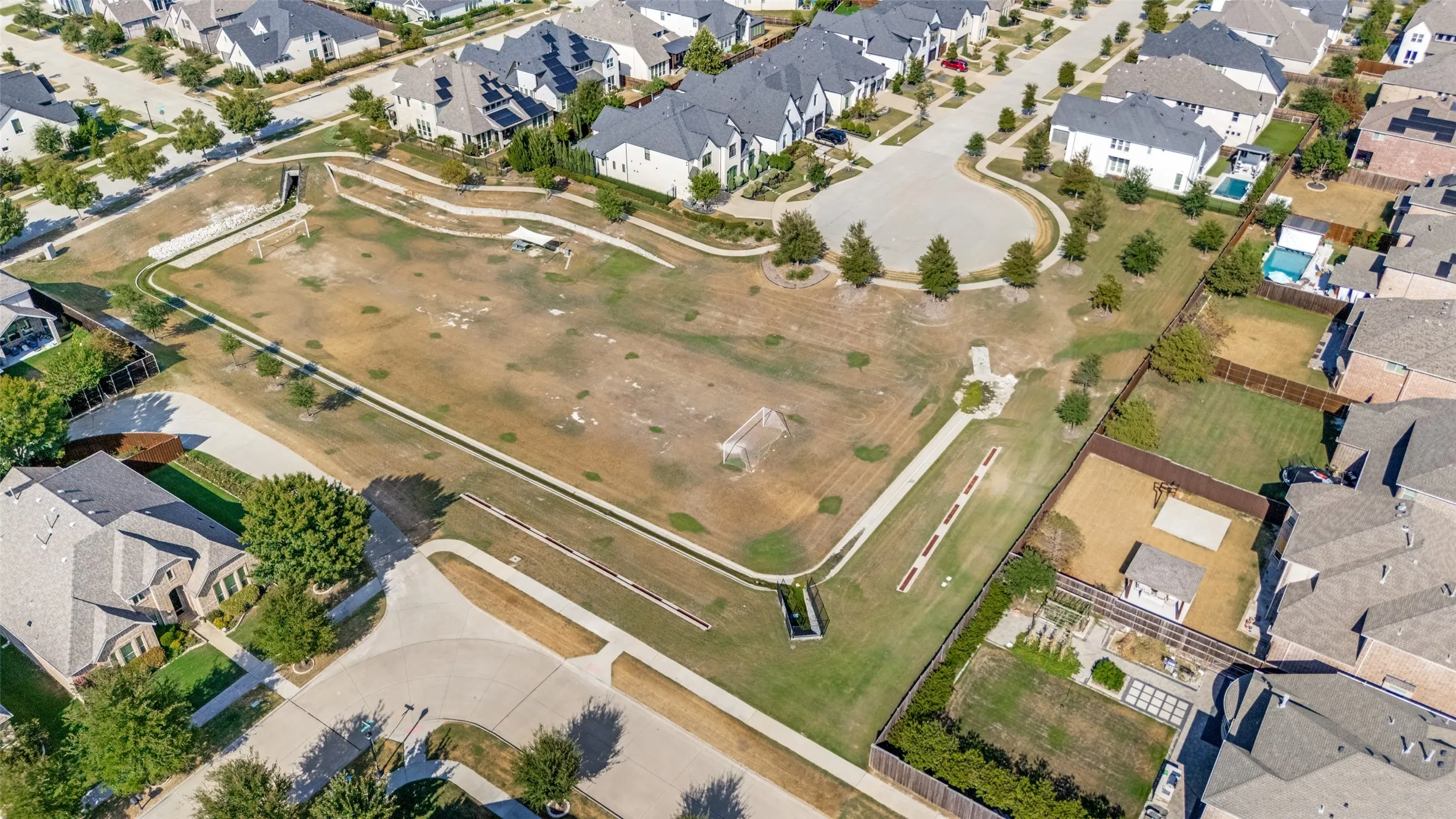 Expansive community green space with walking paths and recreational areas