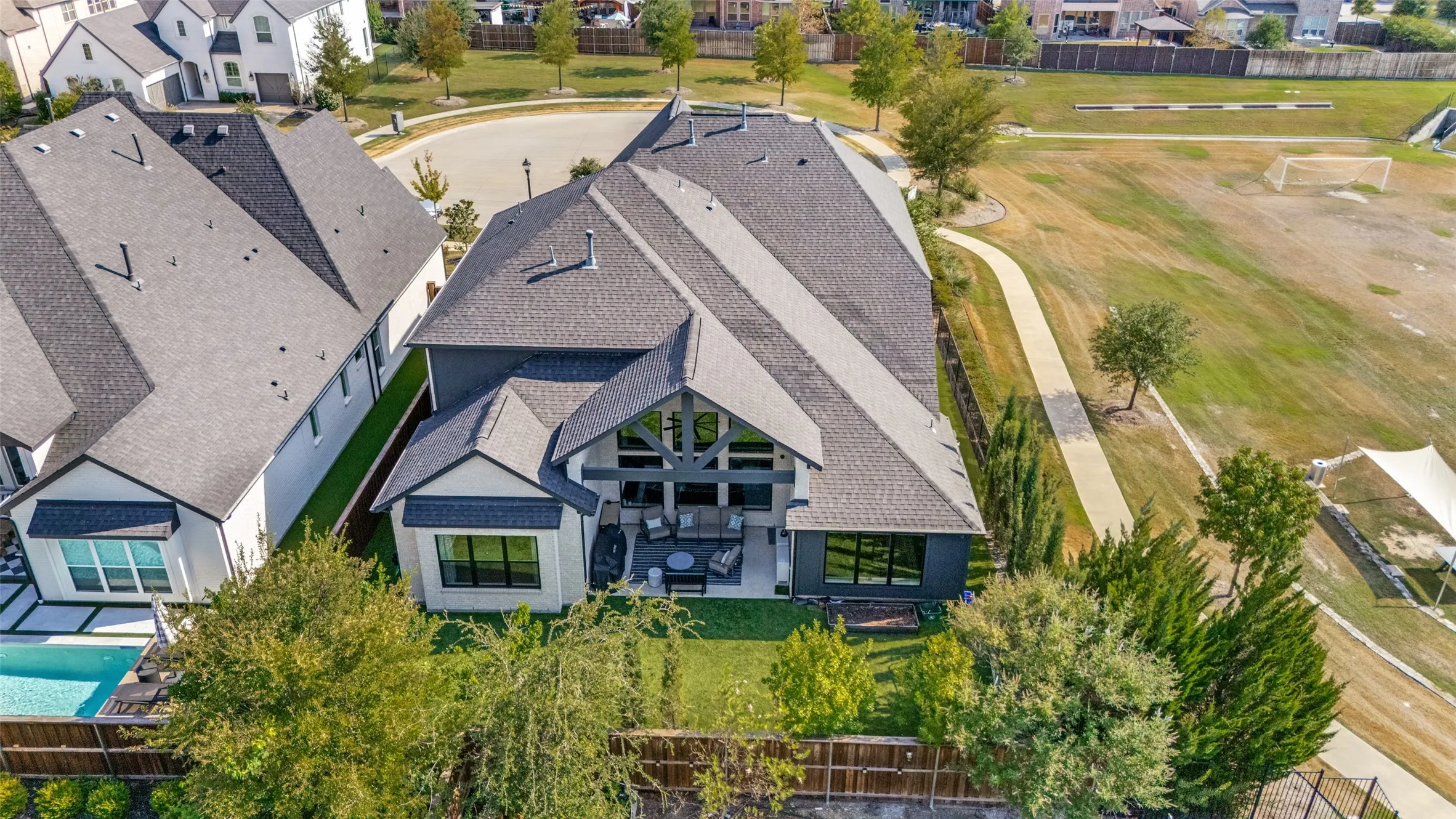 Modern exterior with a multi-gabled roofline and a rear patio
