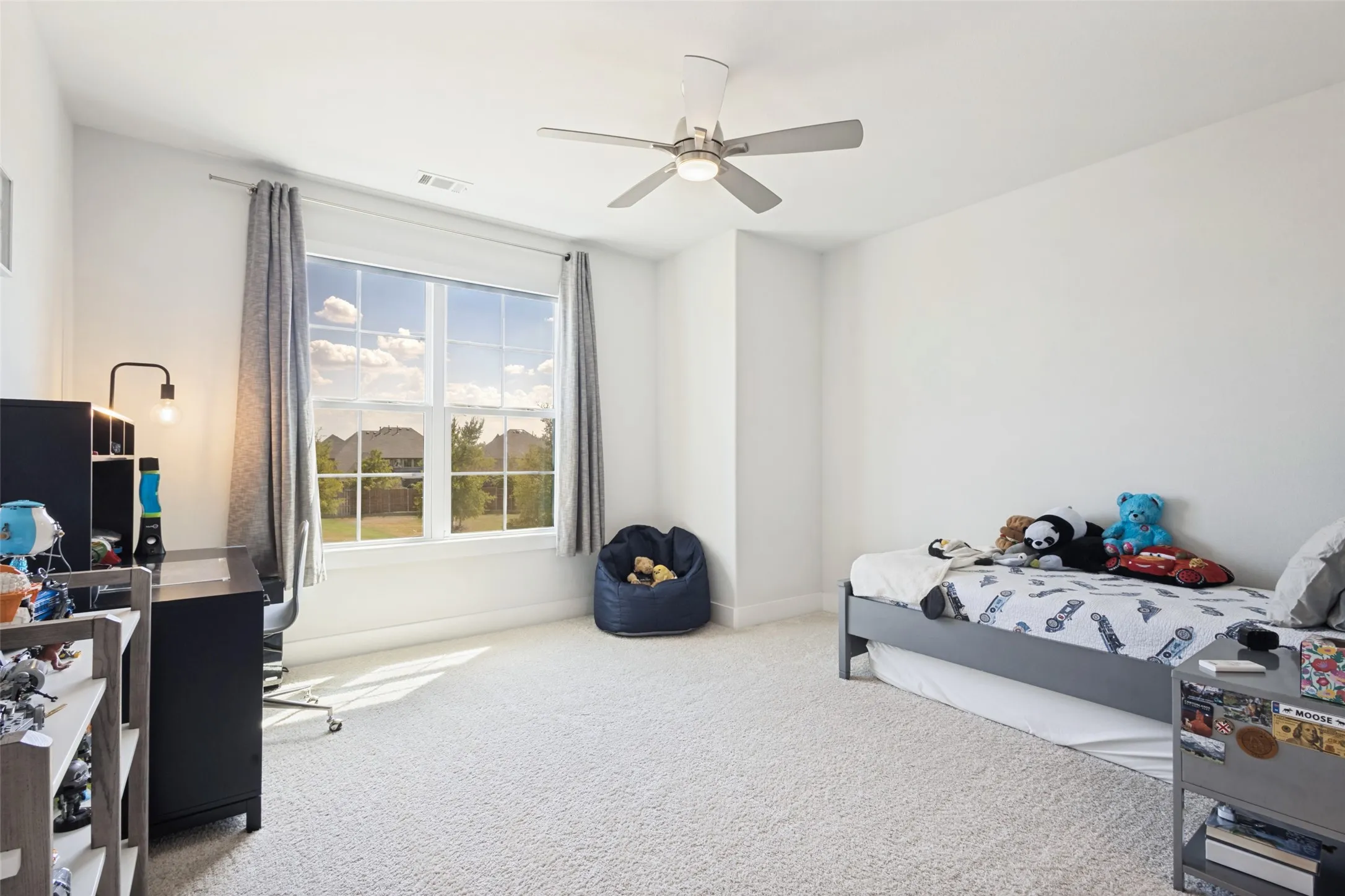 Expansive window, modern ceiling fan with lighting, light-colored carpeting, and light-toned walls