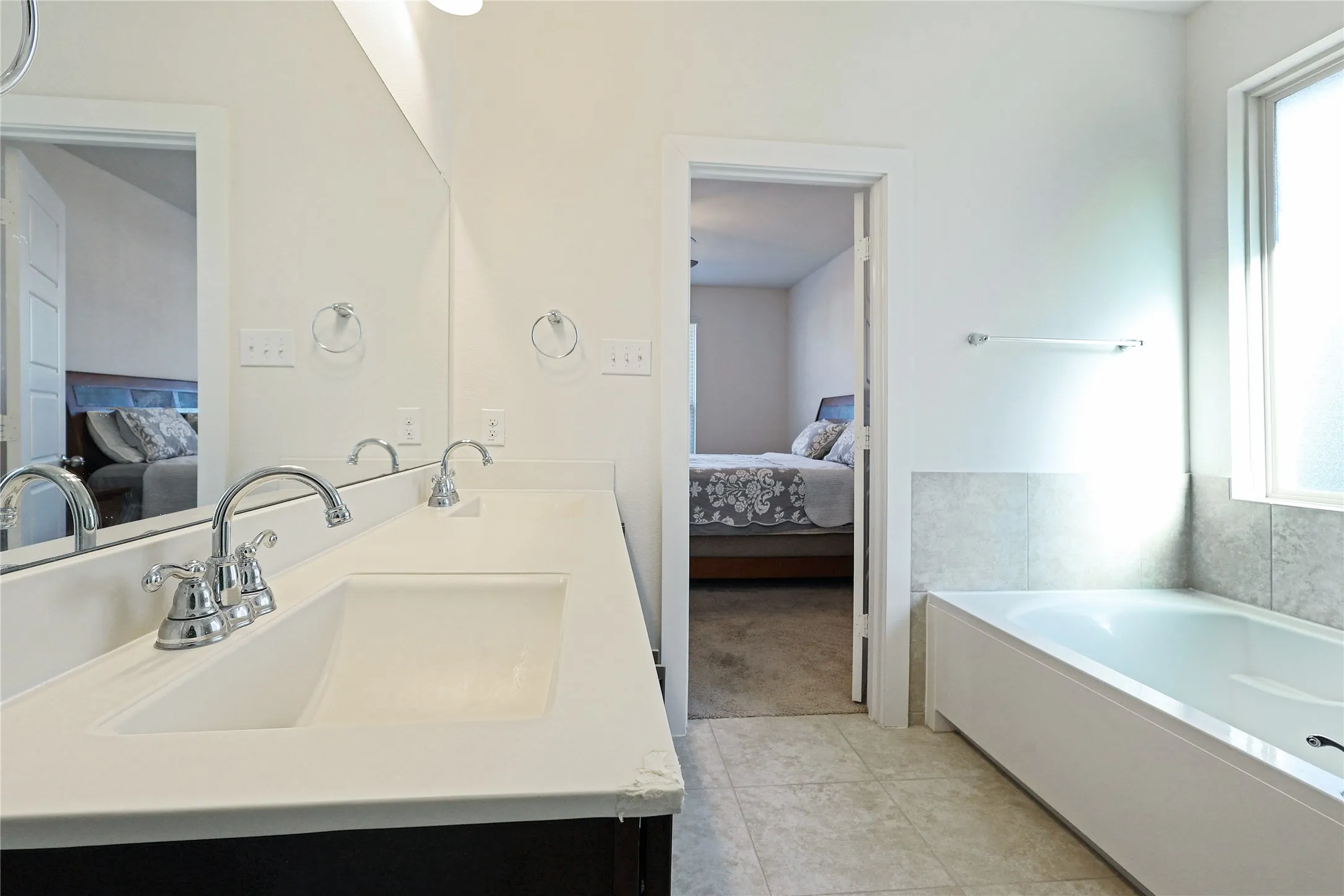 Dual vanity with chrome fixtures and integrated sinks