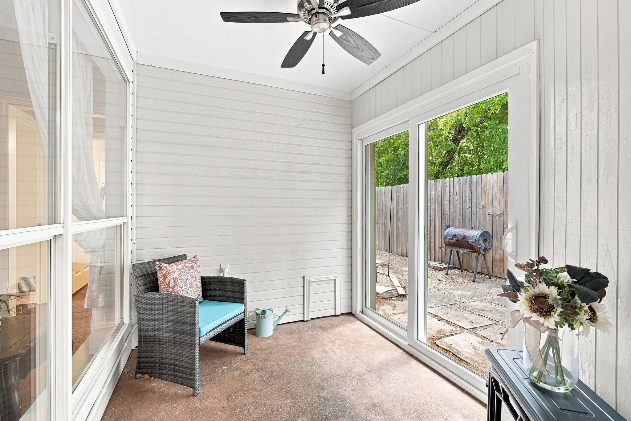 The enclosed sunroom with sliding glass doors leads directly to your private, courtyard area