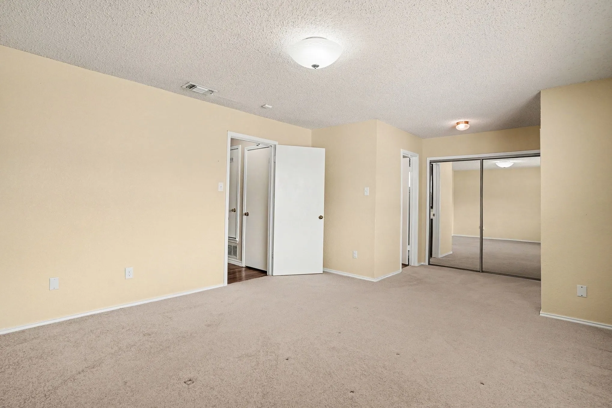 Neutral-toned walls complement plush carpeting