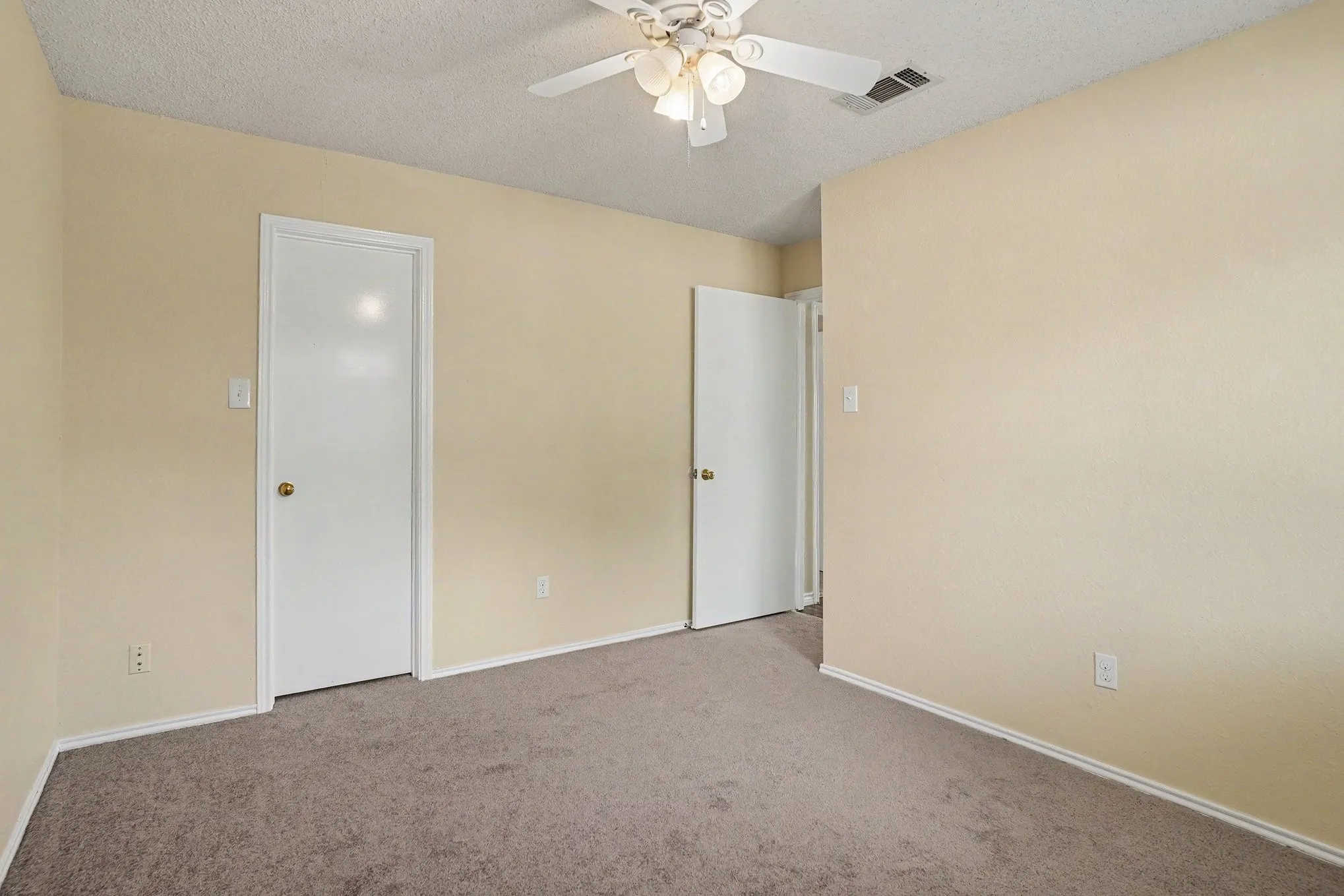 Carpeted flooring, light-toned walls, white trim, and a ceiling fan with integrated lighting