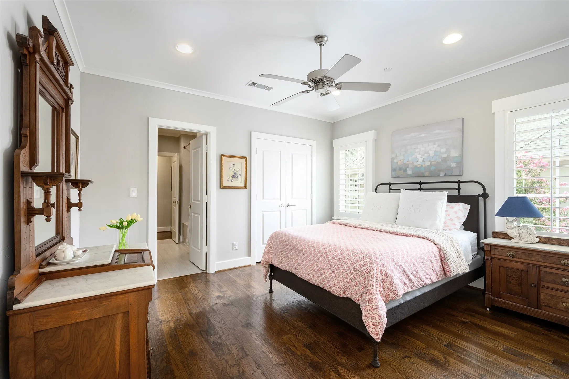Hardwood flooring, crown molding, plantation shutters, ceiling fan with integrated lighting, and recessed lighting
