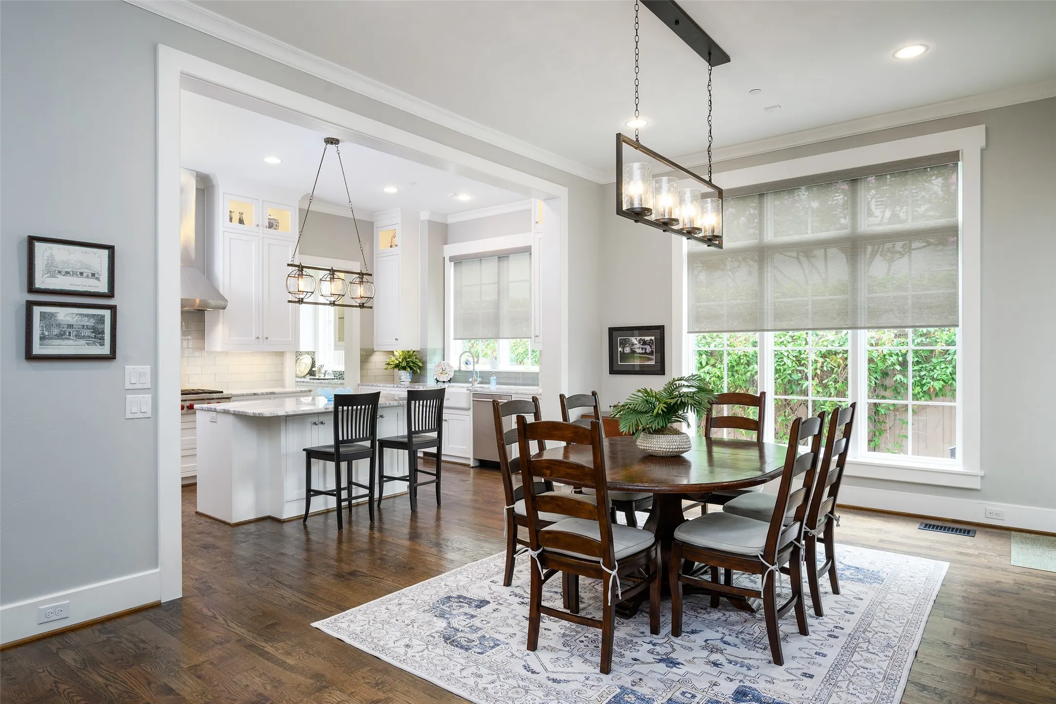 Expansive dining area with hardwood flooring and large windows