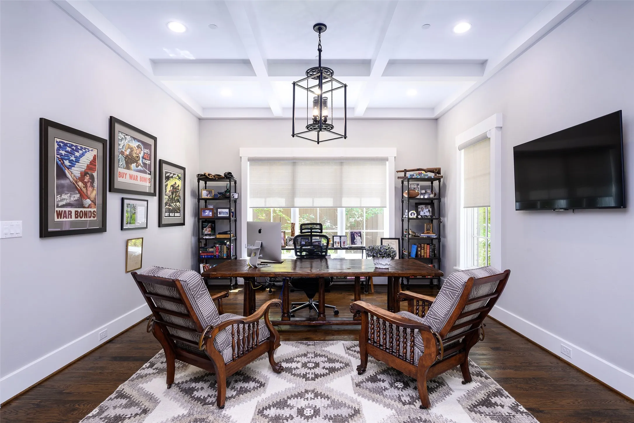 Coffered ceiling with recessed lighting and a central chandelier