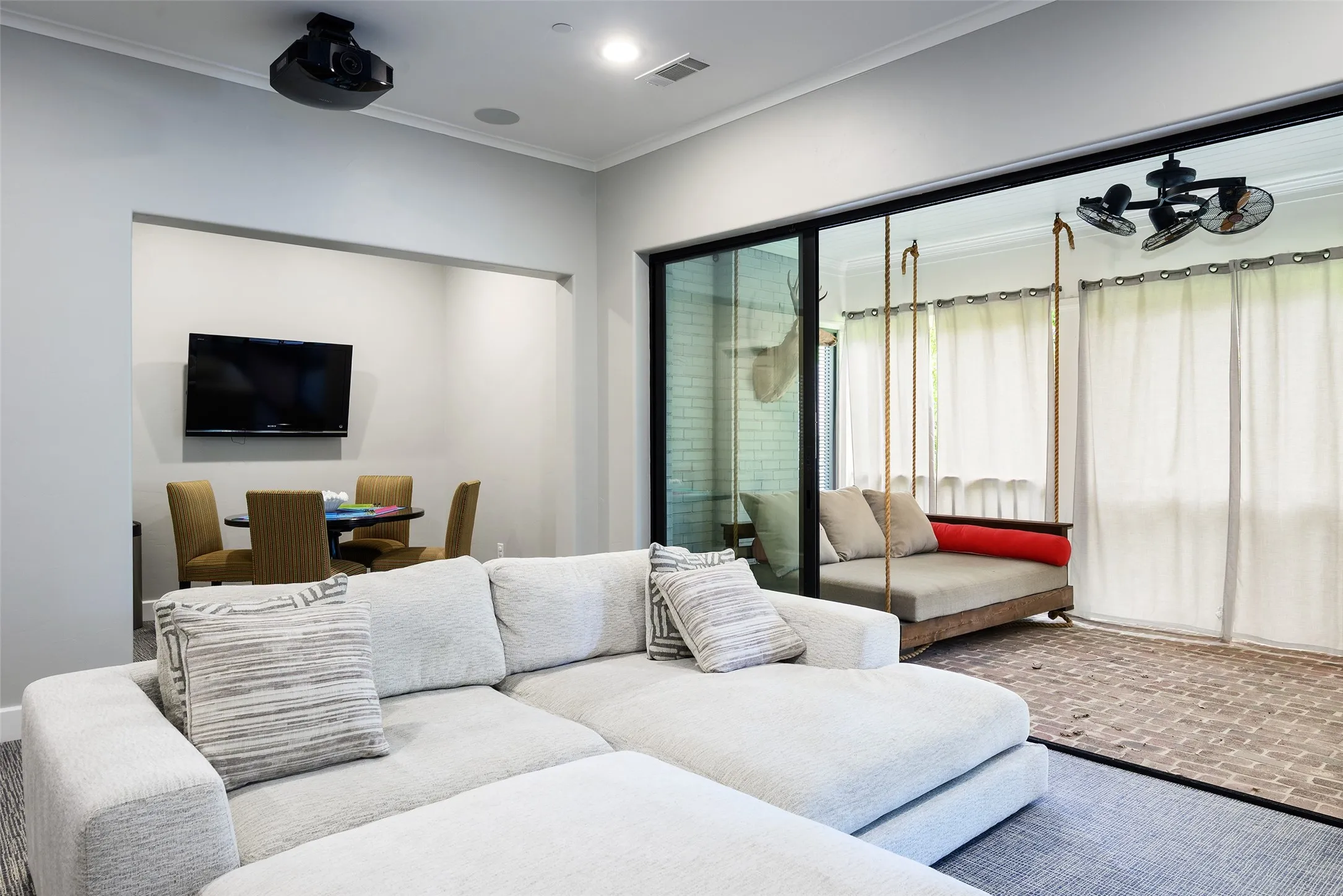 Built-in projector, recessed lighting, and large sliding glass doors