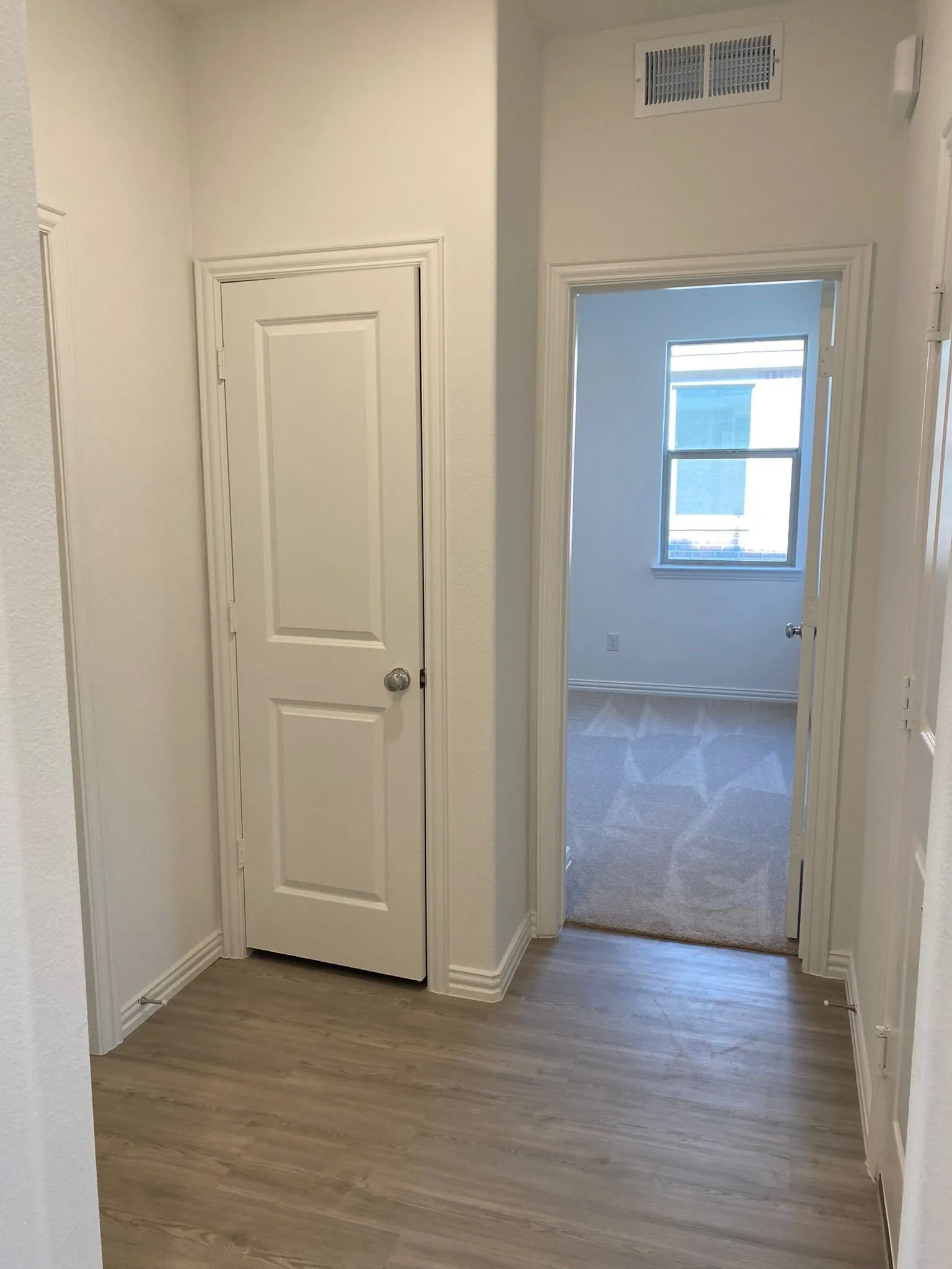 Wood-finish flooring with white trim detailing