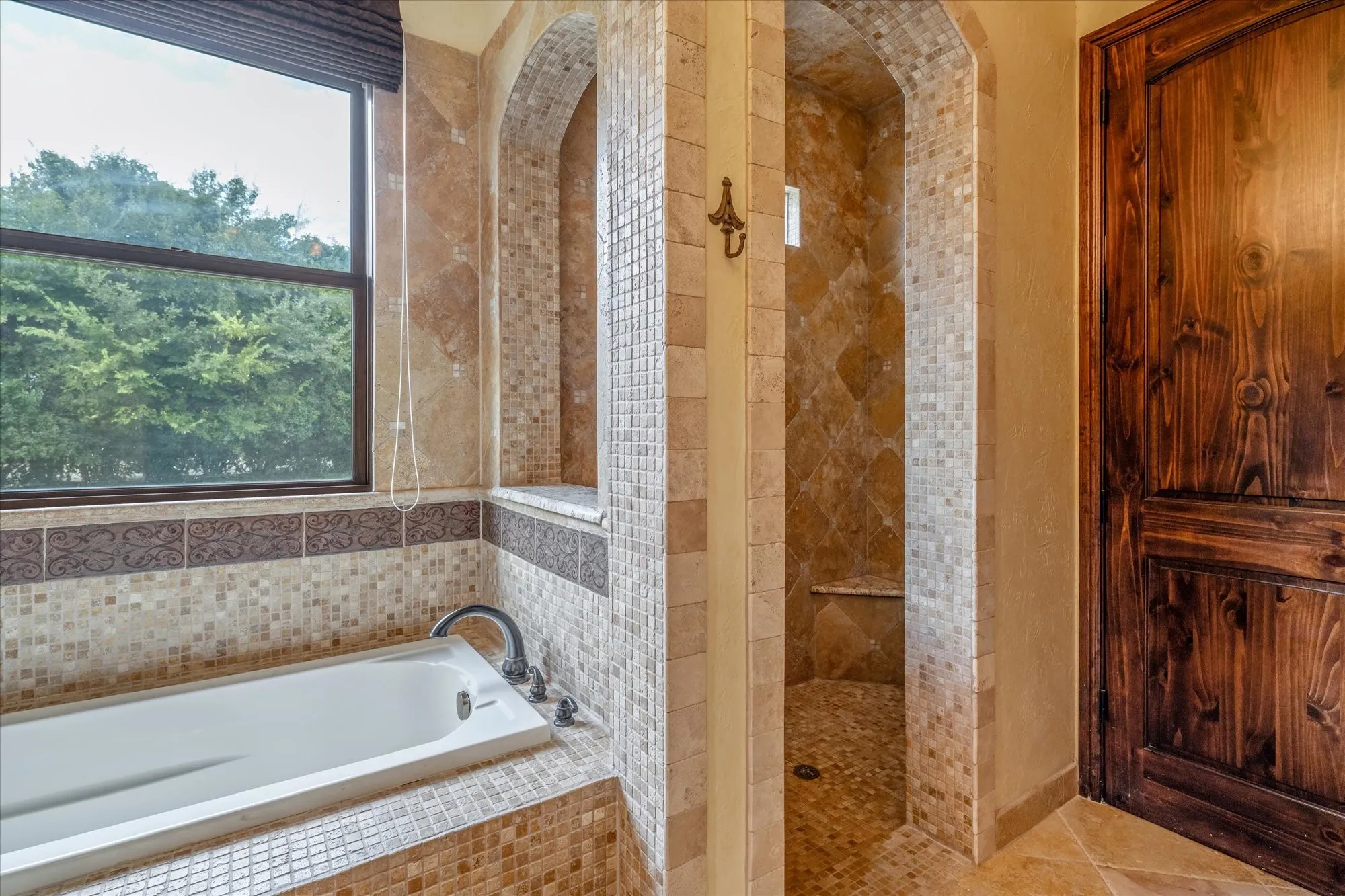 Soaking tub with mosaic tile surround