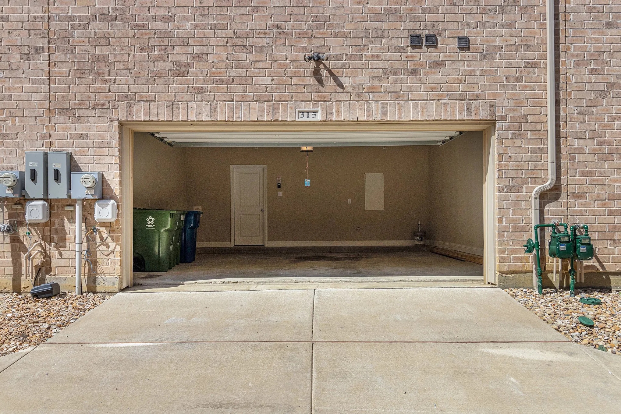 Brick exterior with an integrated garage and concrete driveway
