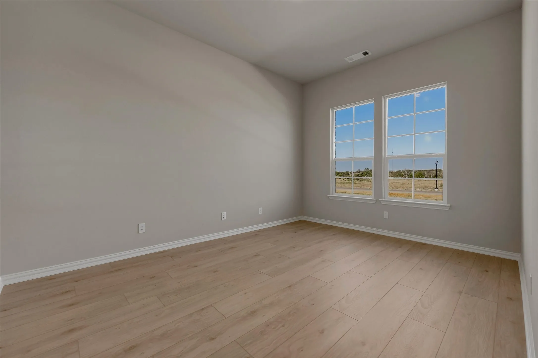 Wood-finish flooring with neutral wall tones and white trim