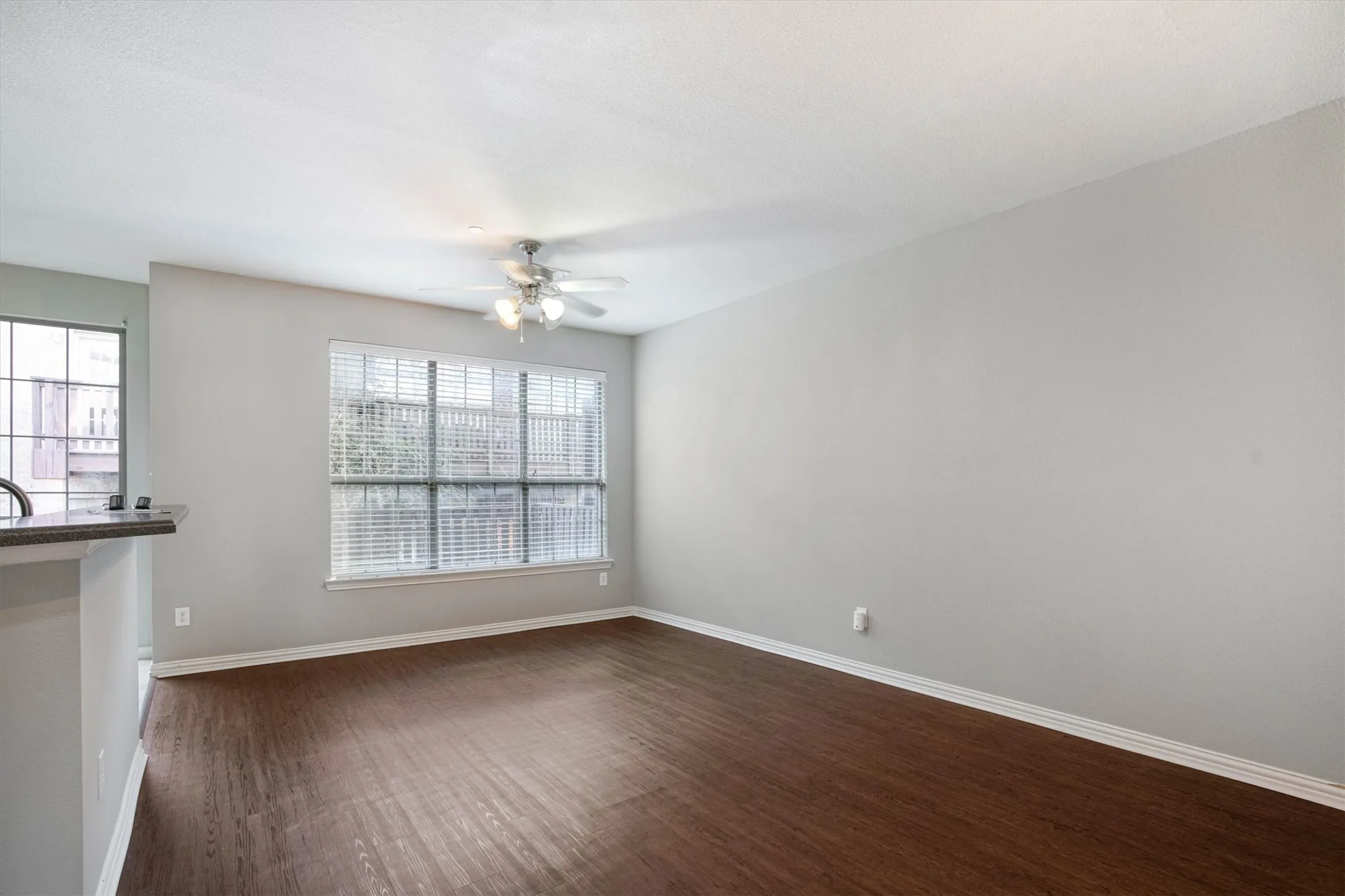 Dining, living area open to the kitchen with a back door balcony patio and fireplace