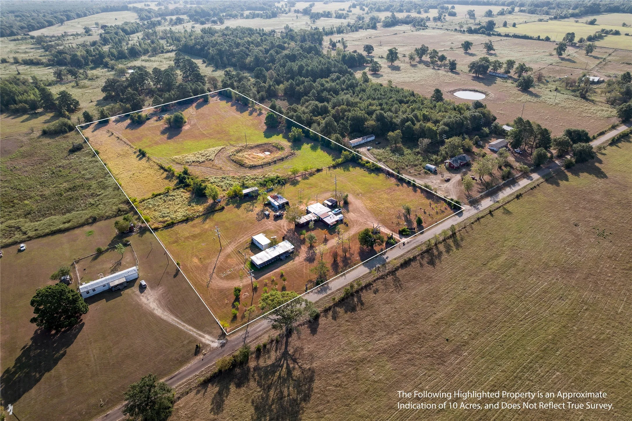 Expansive property featuring varied terrain, a natural pond, and mature tree lines