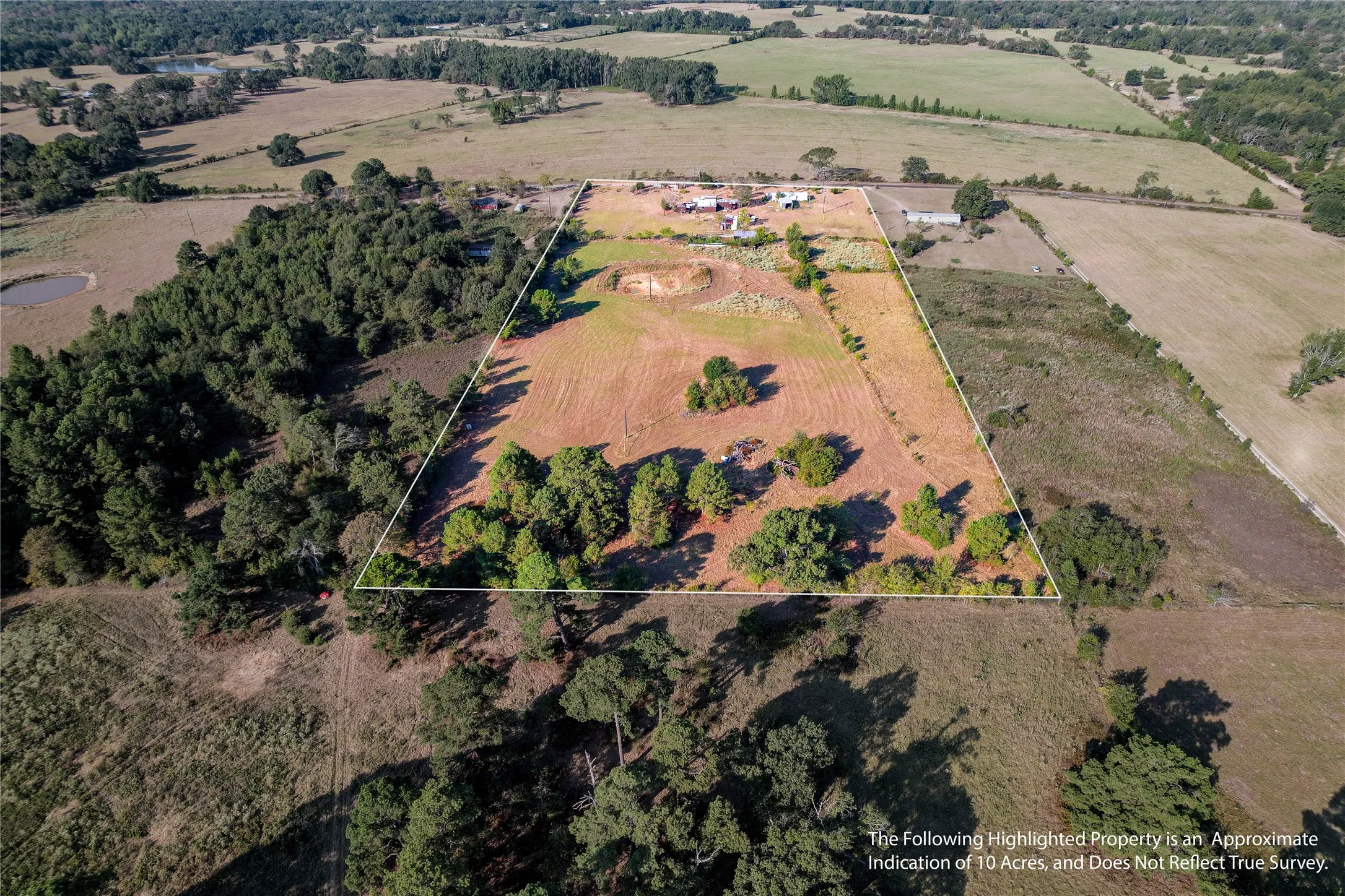 Expansive acreage featuring a mix of open fields and mature trees