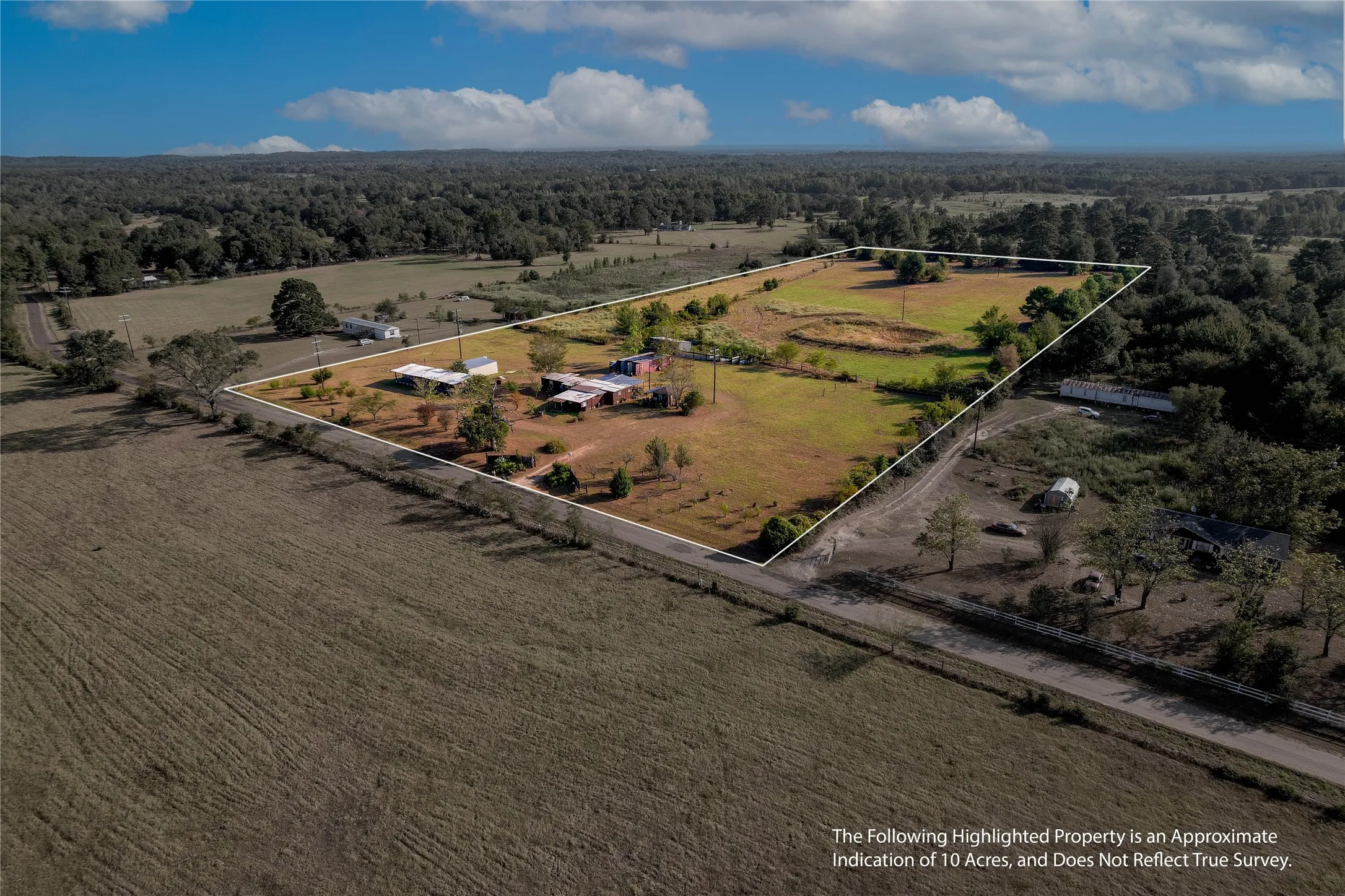 Expansive parcel featuring a rural setting, partial tree coverage, open fields, and a white perimeter line
