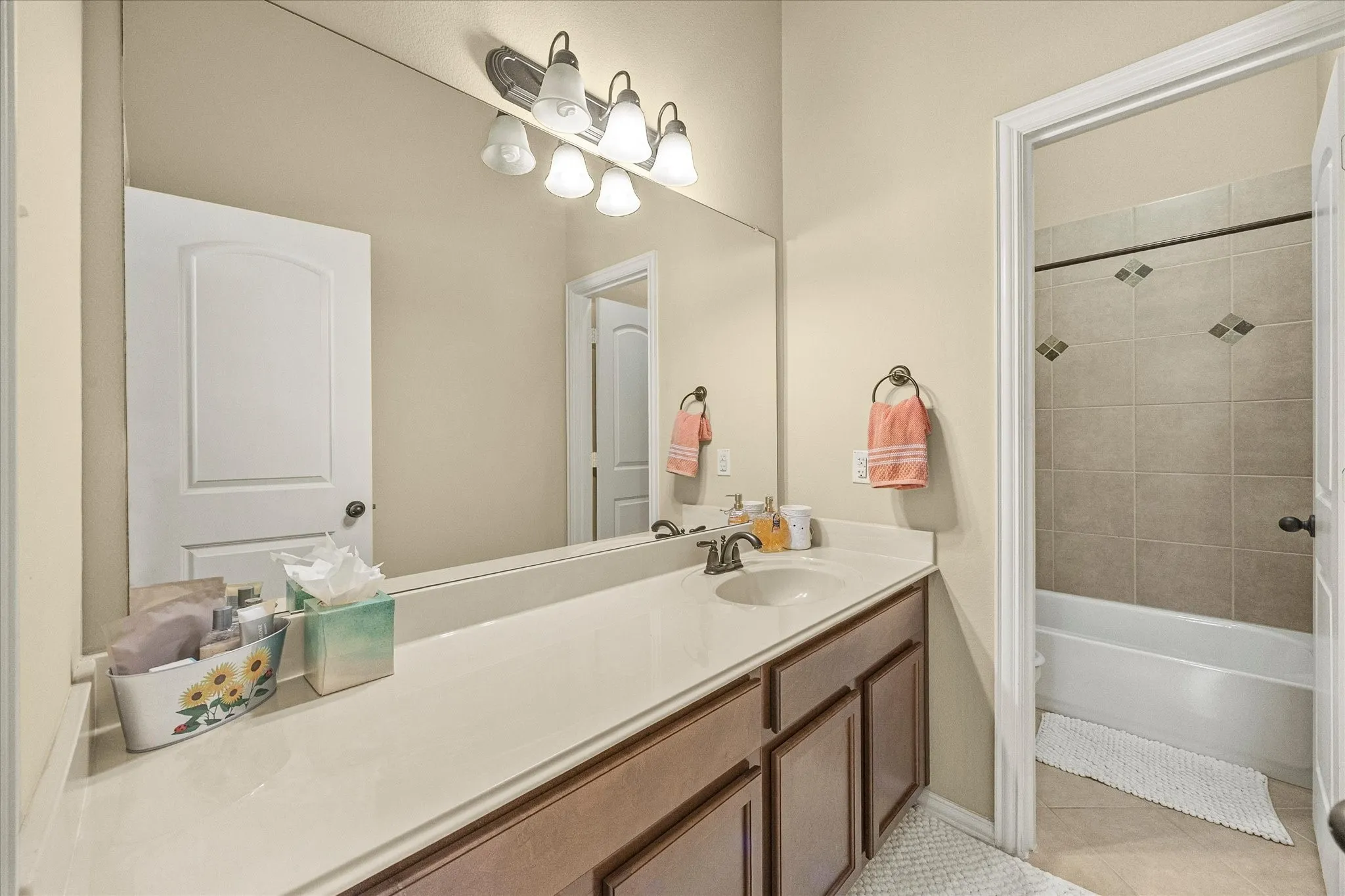 Extended single vanity with an integrated sink and base cabinetry