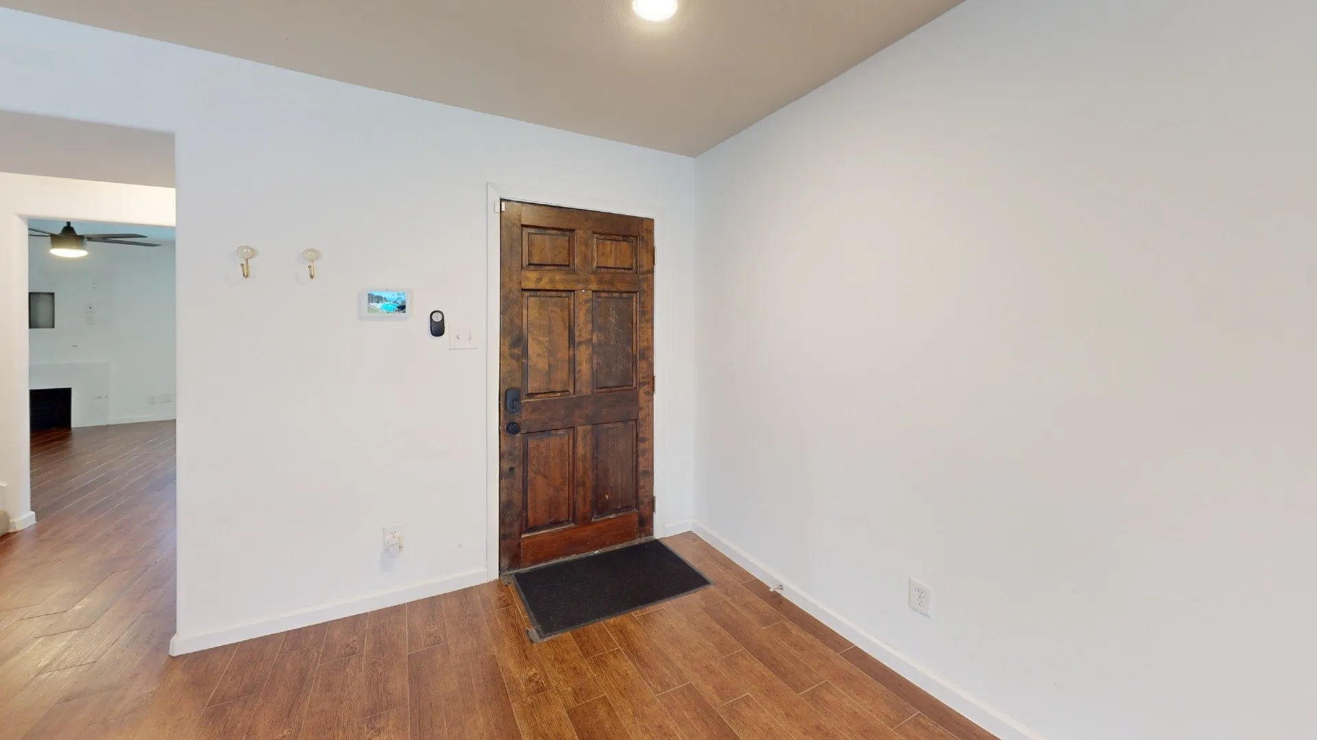Wood-finish flooring and a rich wood-paneled door