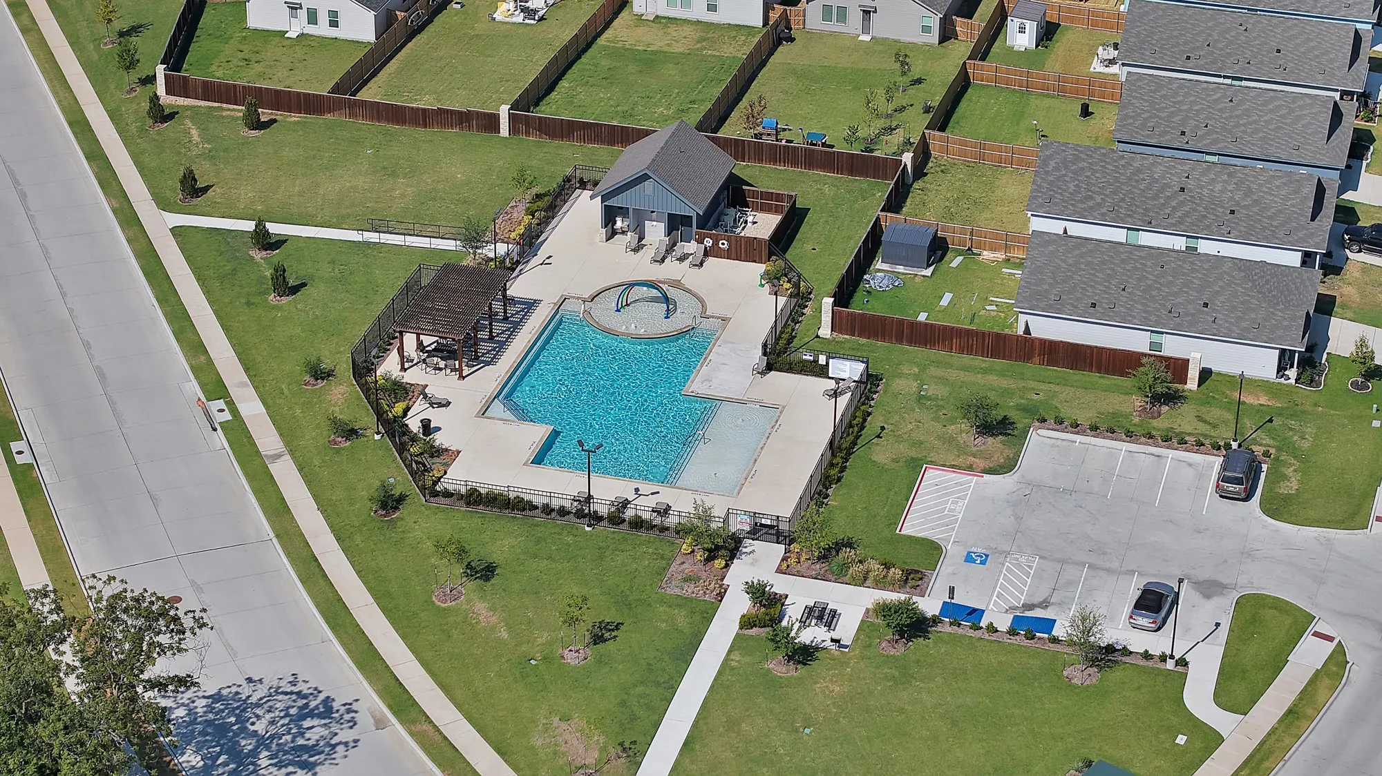 Community swimming pool with an integrated spa and separate wading area