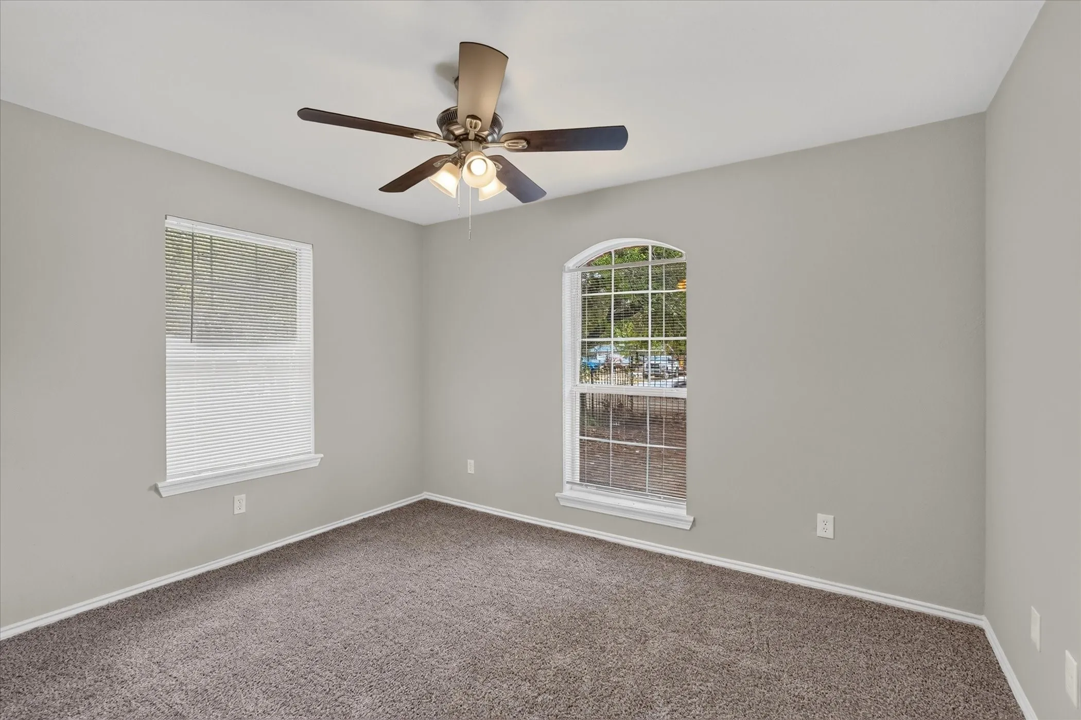Neutral paint palette and brown carpet flooring