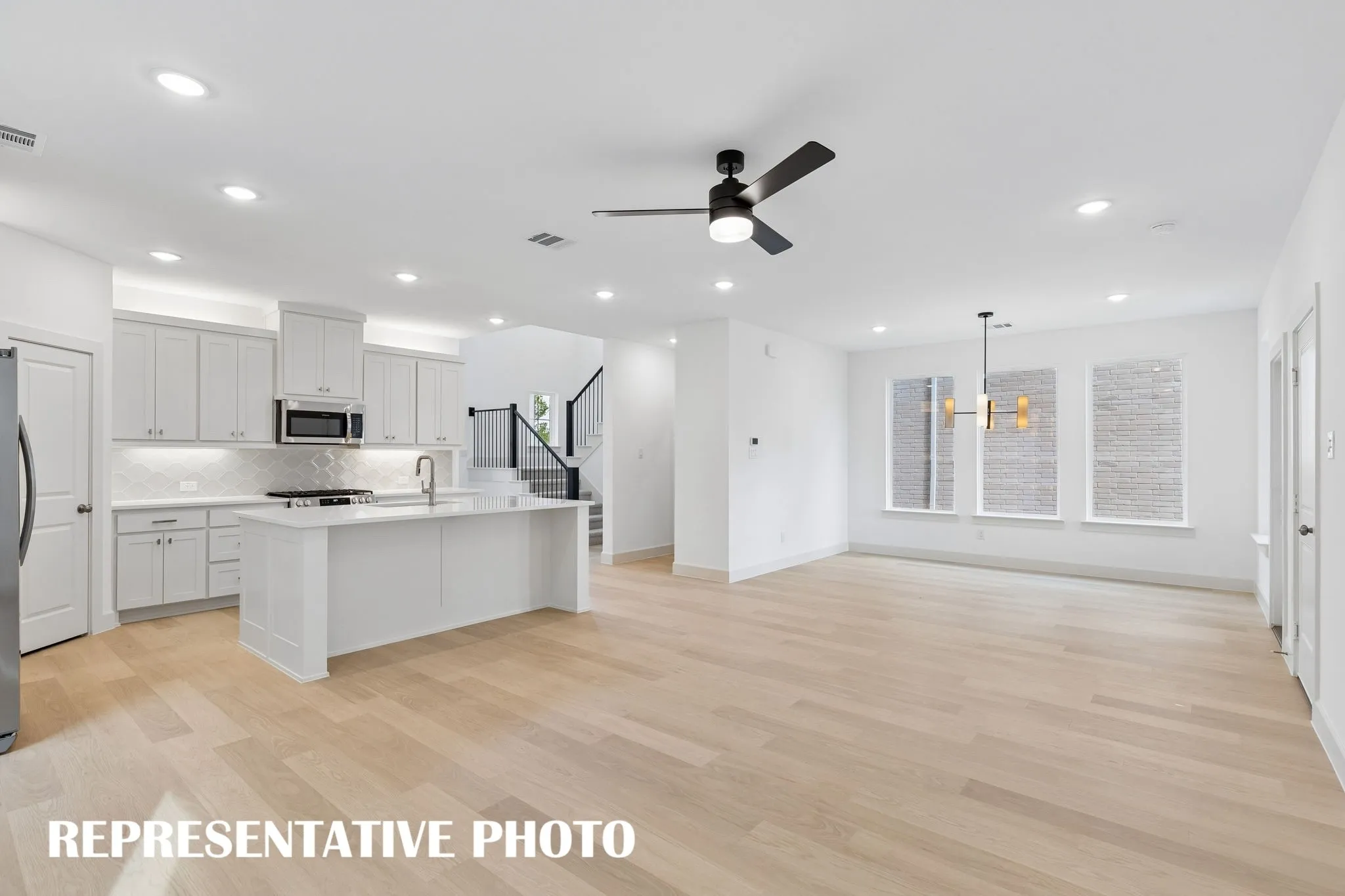 With the kitchen open to the family and dining rooms, entertaining is a breeze in our Louis floor plan.  REPRESENTATIVE PHOTO