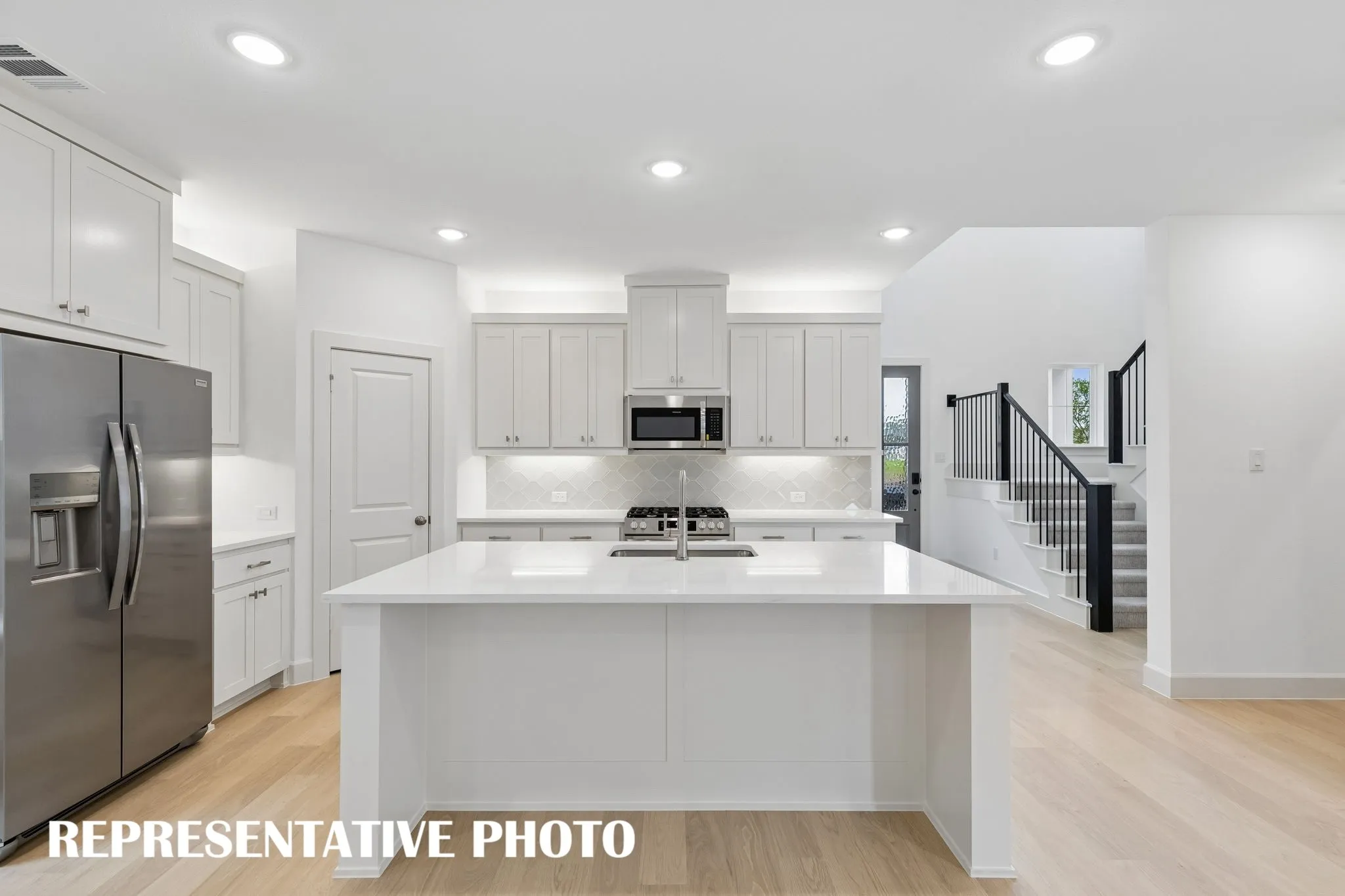The spacious kitchen island is the hub of your new dream kitchen offering the perfect gathering space for friends and family.  REPRESENTATIVE PHOTO