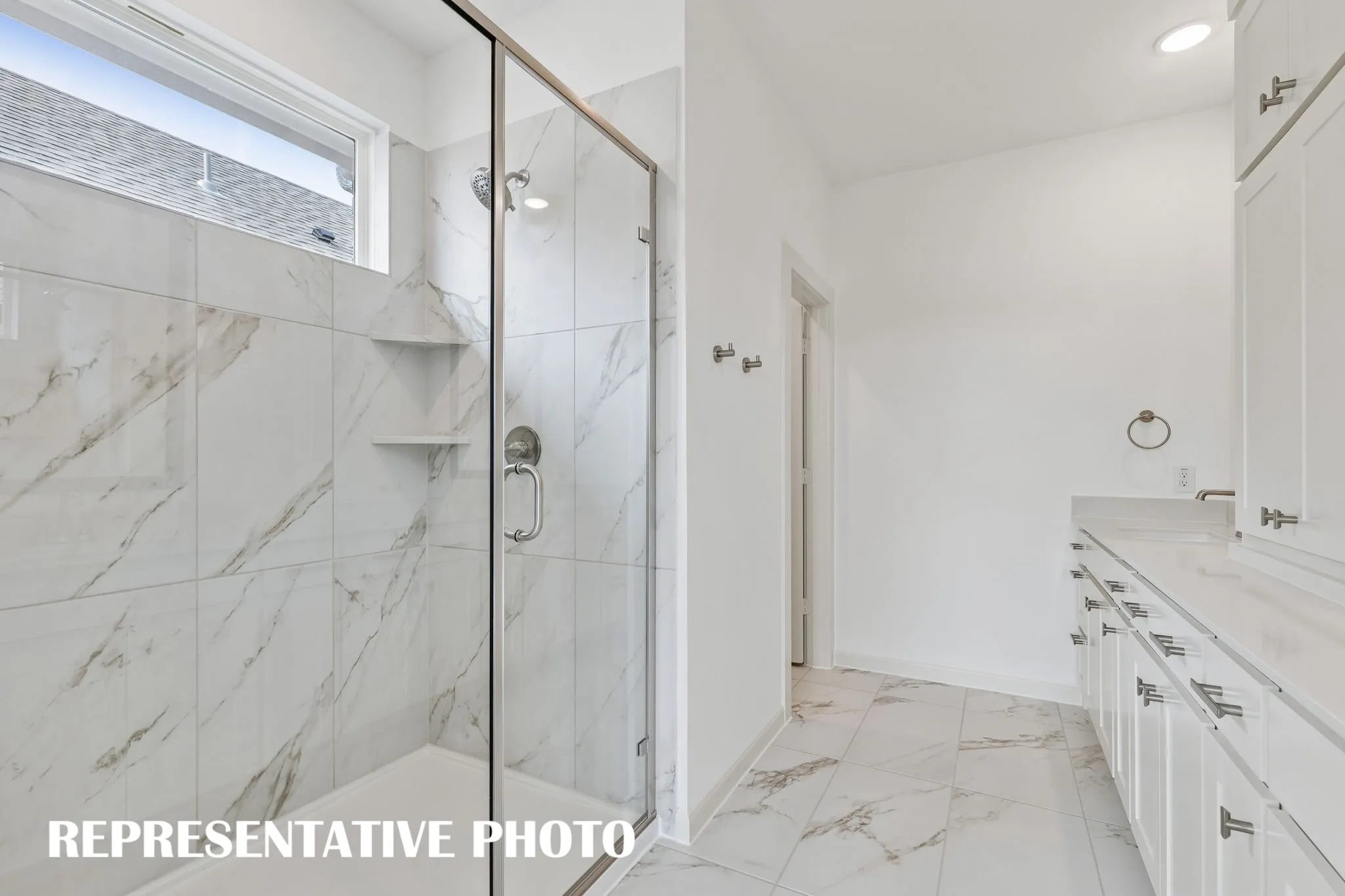 Featuring an oversized walk in shower, this dream owner's bath is waiting for you to call it your own!  REPRESENTATIVE PHOTO