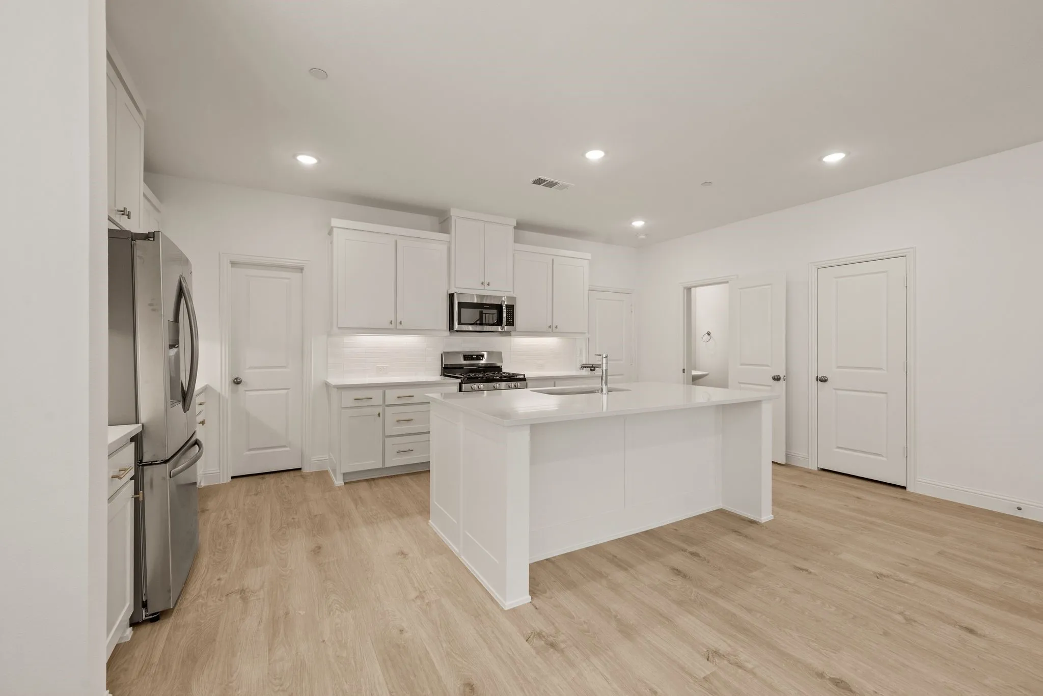 Complete with refrigerator, microwave and range plus quartz counters.