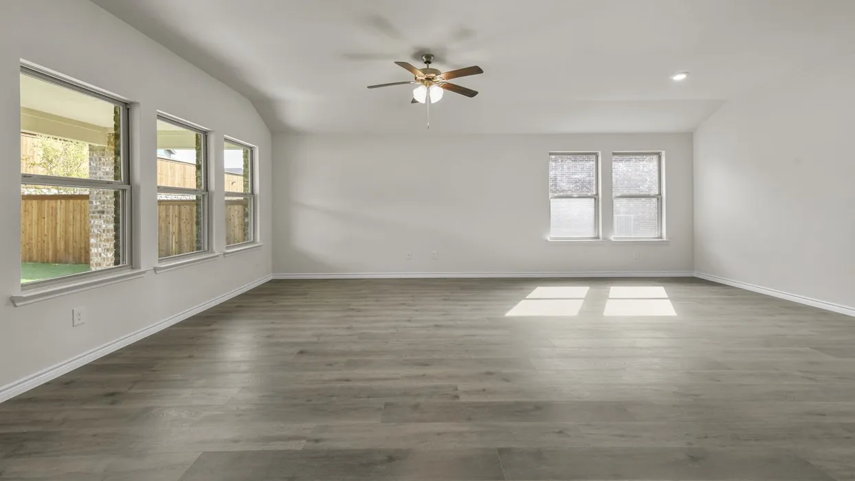 Spacious interior featuring wood-finish flooring, vaulted ceilings, and recessed lighting