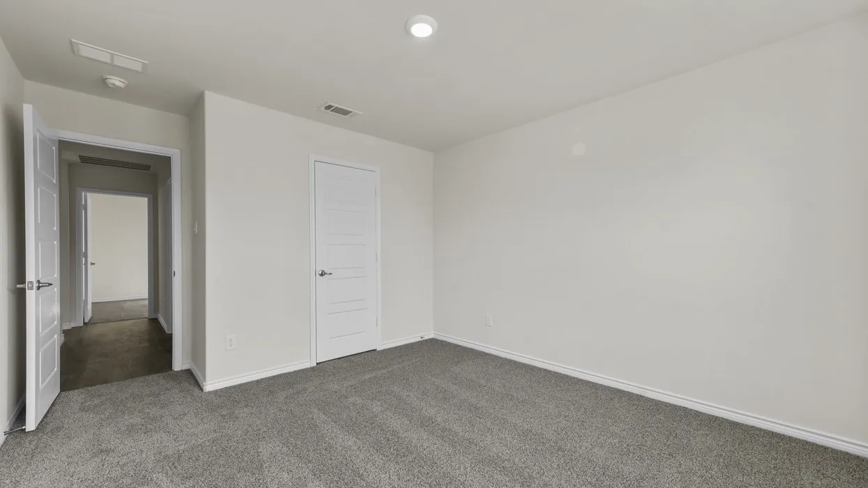 Room featuring light gray carpeting, white painted walls, and a white ceiling