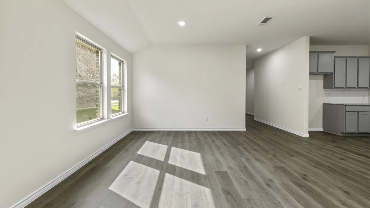 Spacious room featuring wood-finish flooring, recessed lighting, and a neutral color palette