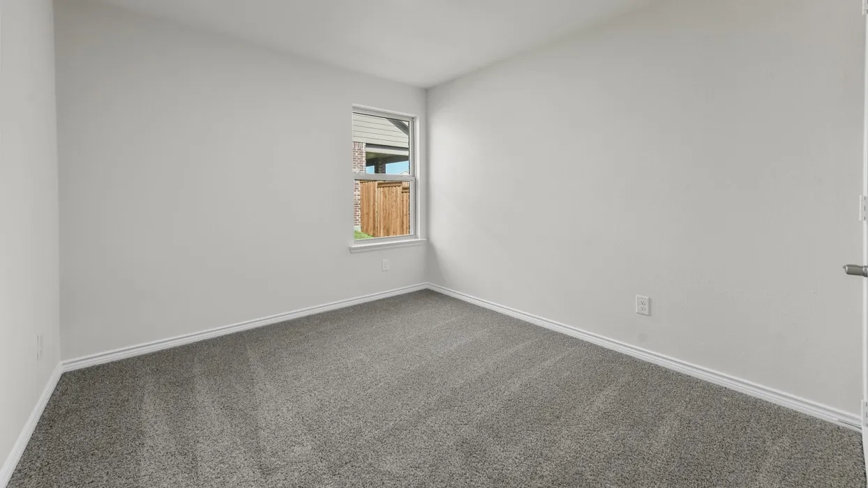 Carpeted room featuring a single window and light gray walls