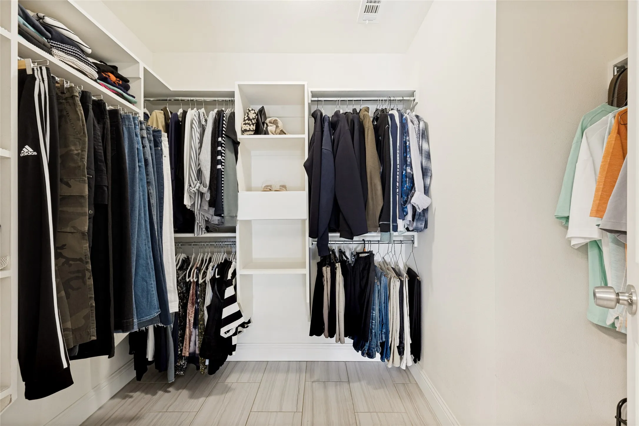 Primary closet with storage shelves.