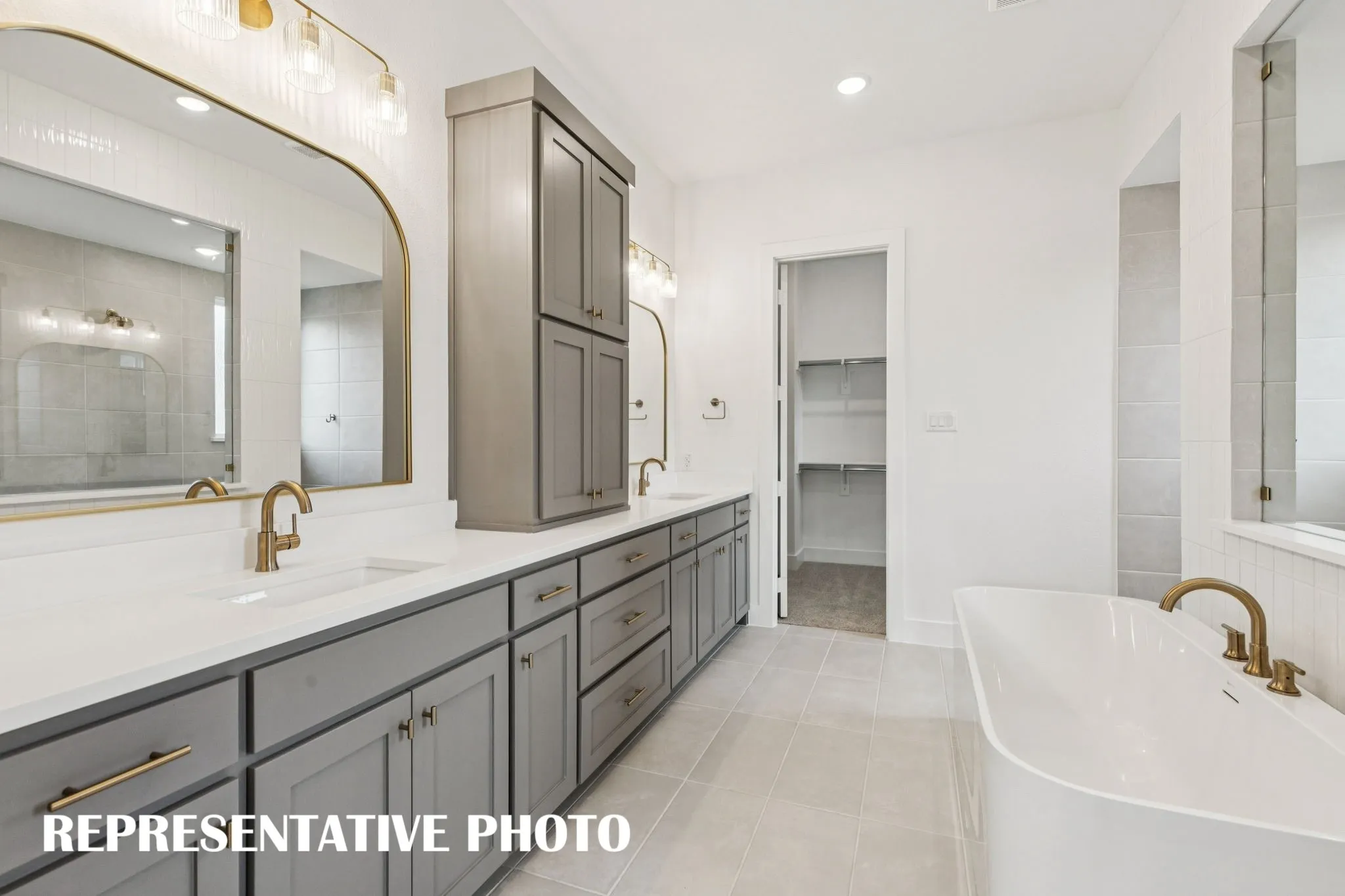 Beautifully finished in a neutral color palette, this owner's bath provides ample room for two!  REPRESENTATIVE PHOTO