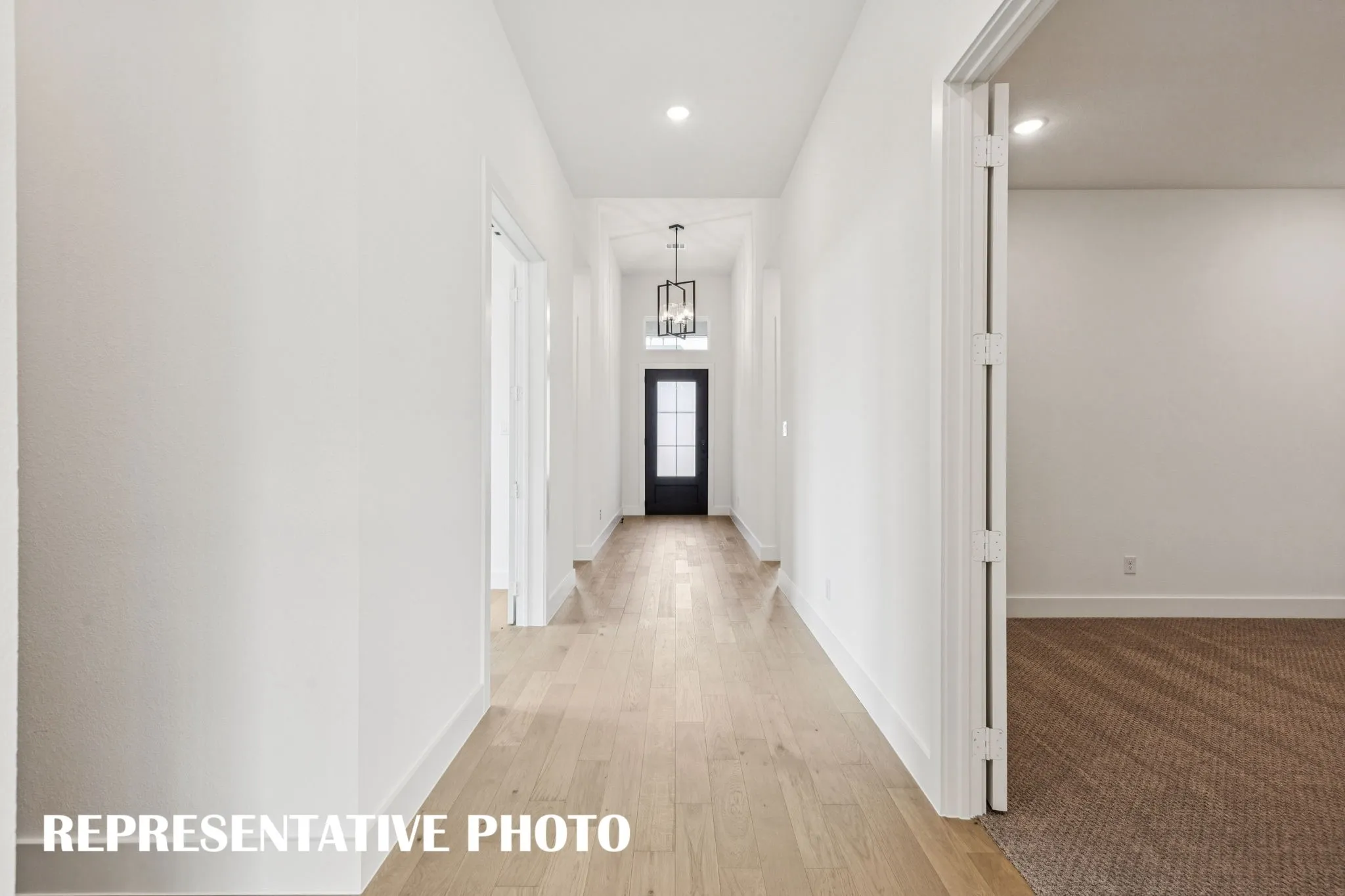 Welcome into this beautiful home featuring lovely flooring, 8' glass entry door and outstanding space to showcase your art work!  REPRESENTATIVE PHOTO