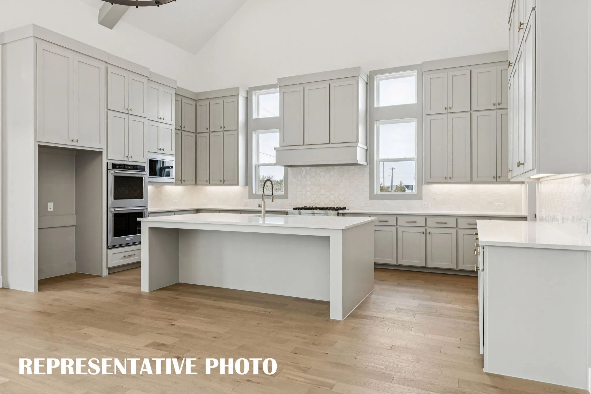 The spacious kitchen island offers the perfect place for friends and family to gather round!  REPRESENTATIVE PHOTO