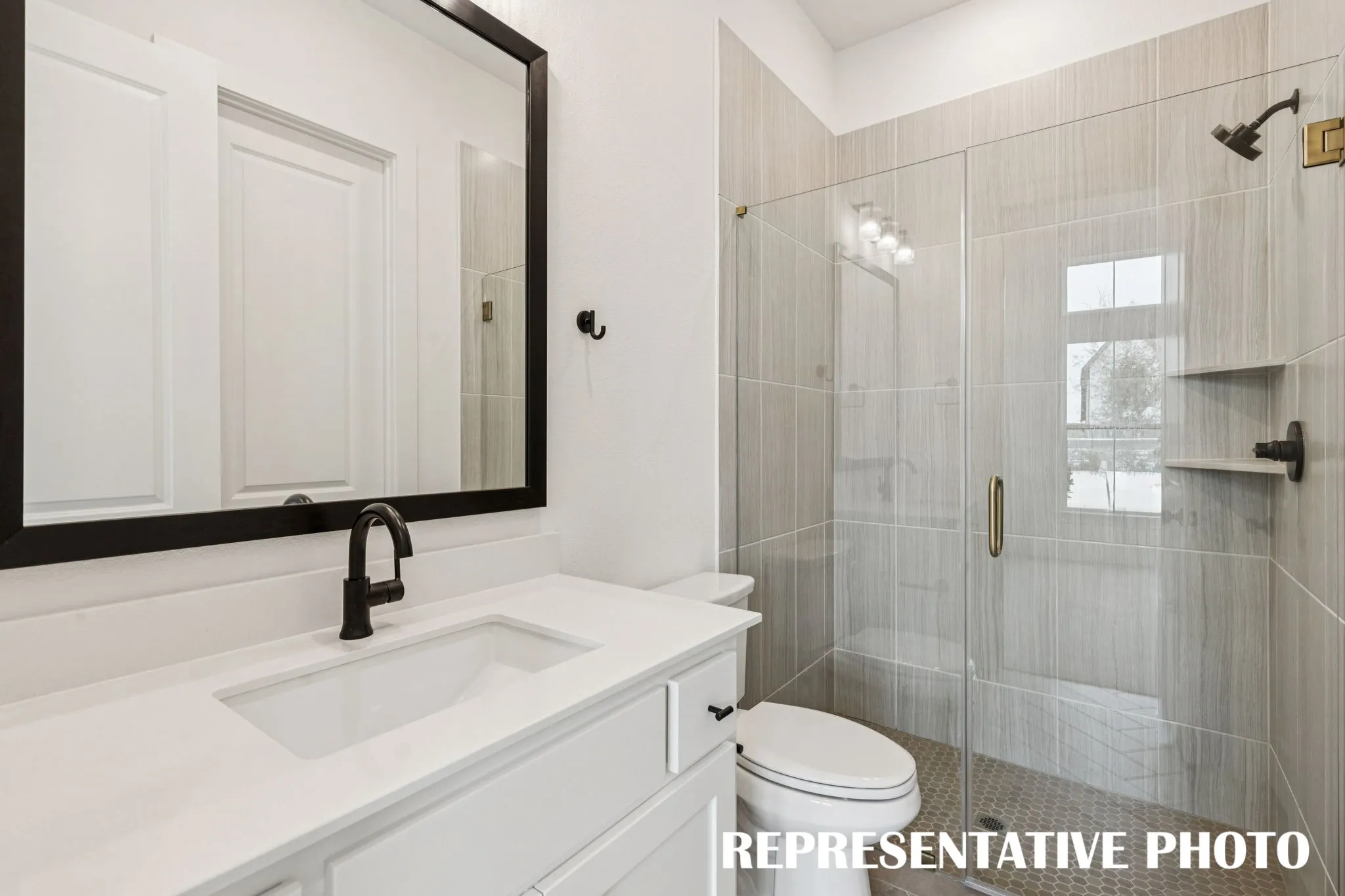 Friends and family will feel right at home in any of the beautifully finished guest baths featured in our Chloe III plan.  REPRESENTATIVE PHOTO